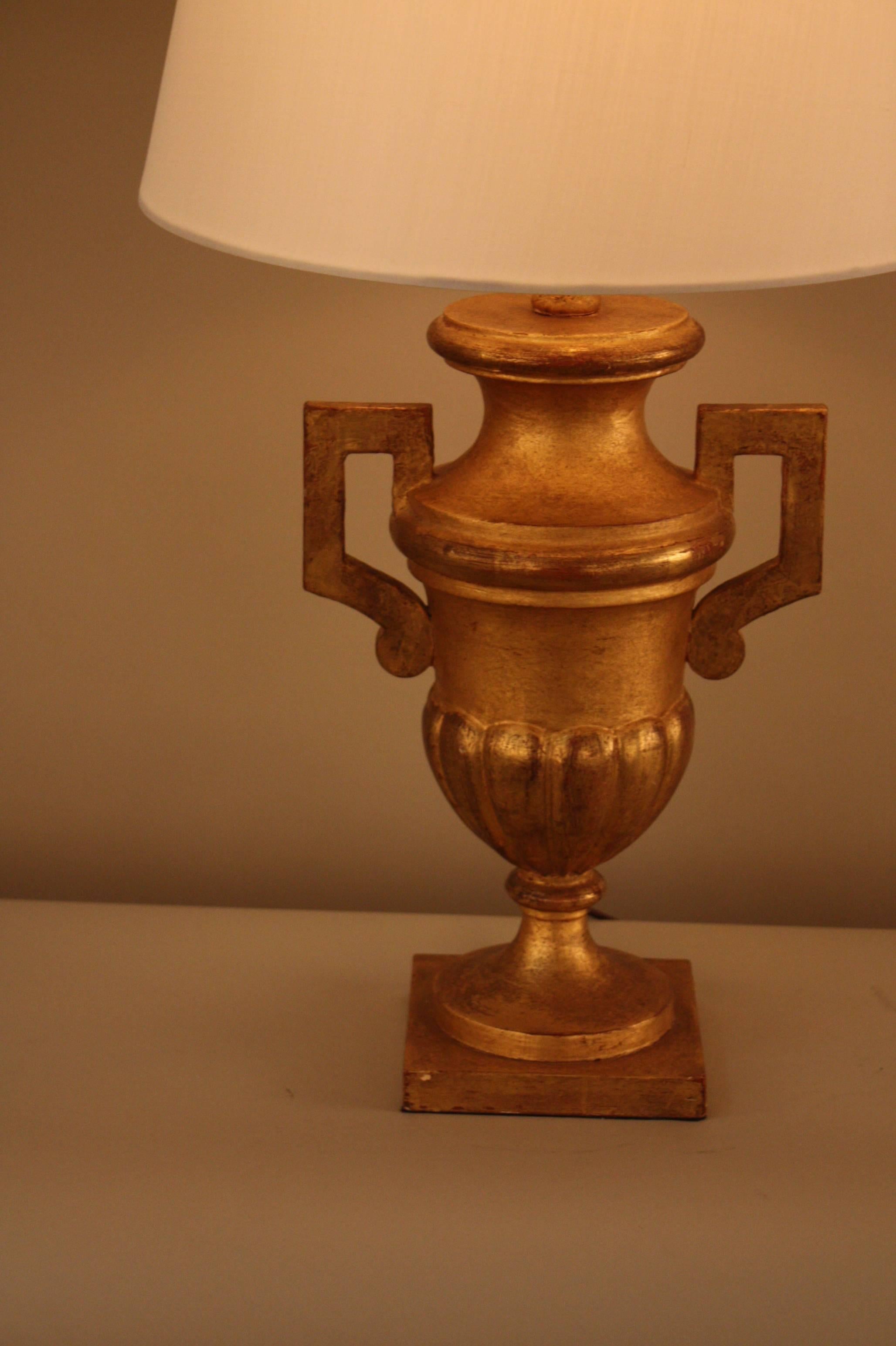 An Italian 1930 Classic urn shape giltwood table lamp fitted with hardback silk lampshade.