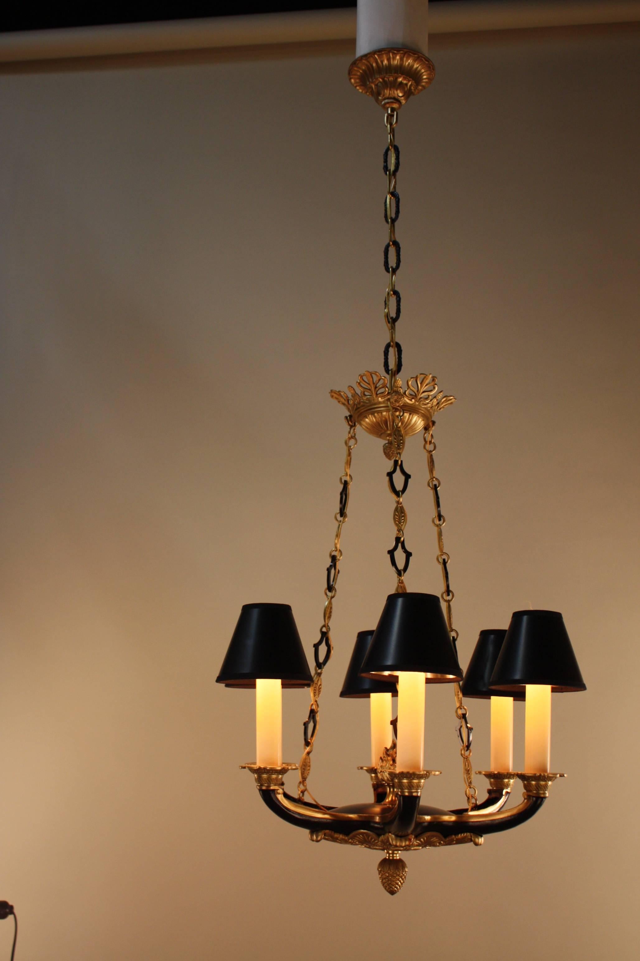 A six-light Empire style French bronze chandelier. This chandelier has been finished in black lacquer over bronze with great detail which is true workmanship of the period.