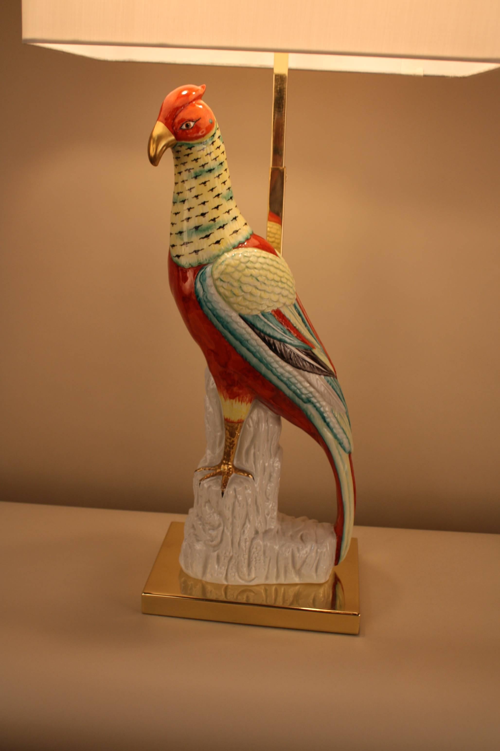 A fantastic adjustable height custom-made lamp with polished bronze base and multi color porcelain bird.
Measurement is including the shade.