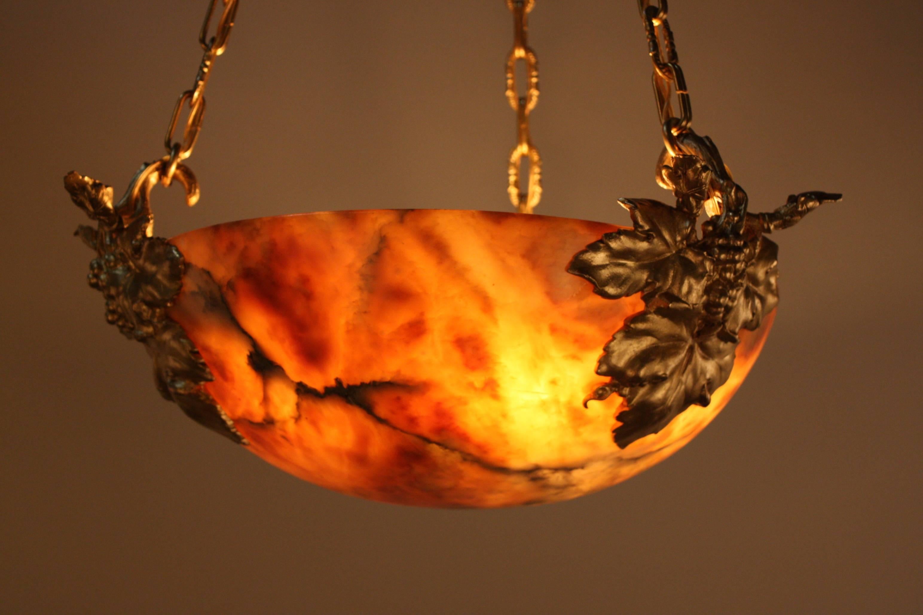 This six-light chandelier is made of beautiful warm colored alabaster, with a fantastic bronze pendant. The pendant itself features great bronze detail as well.