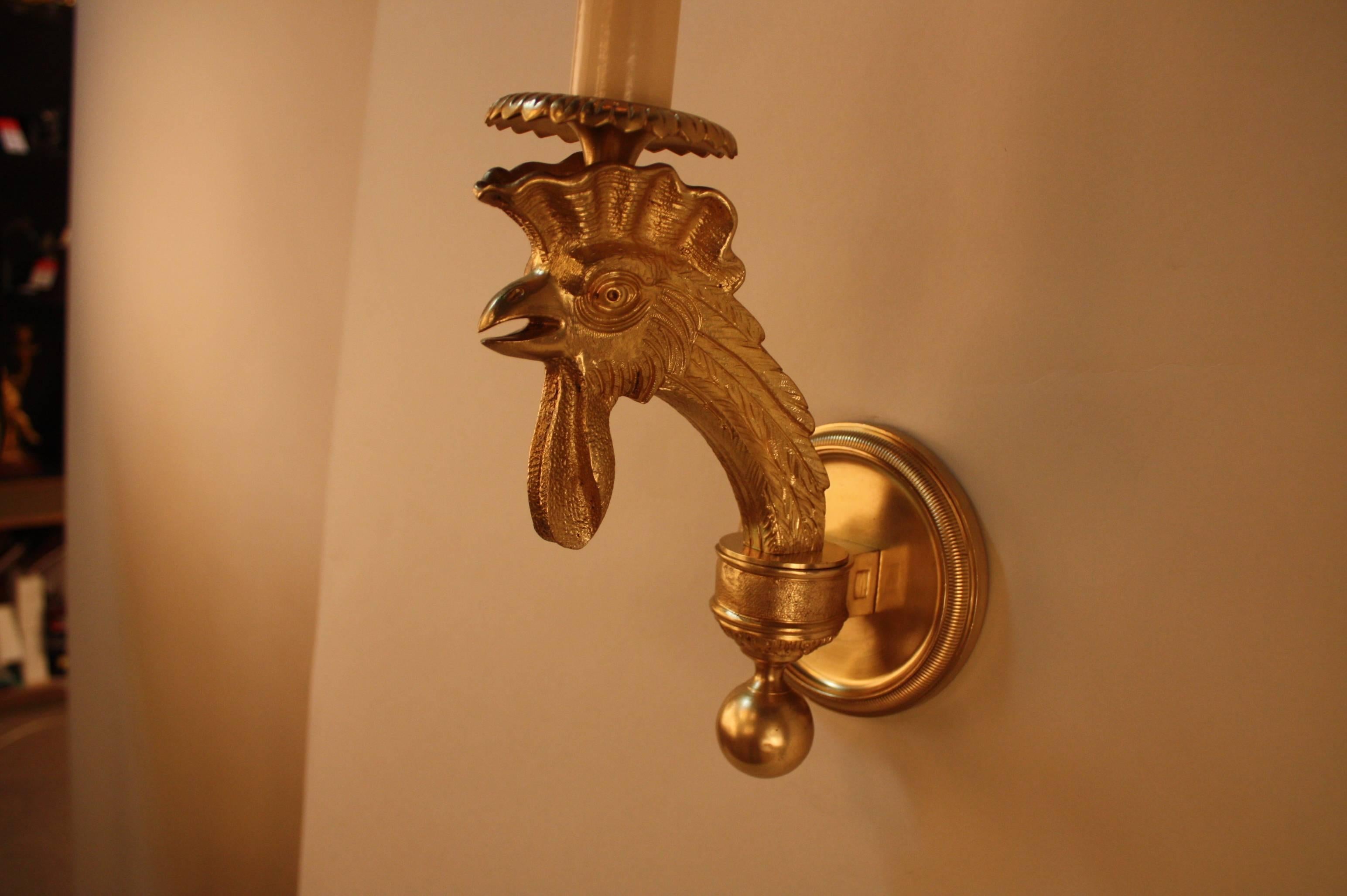 Fabulous pair of single light wall sconces with beautiful bronze sculptured rooster head arm.