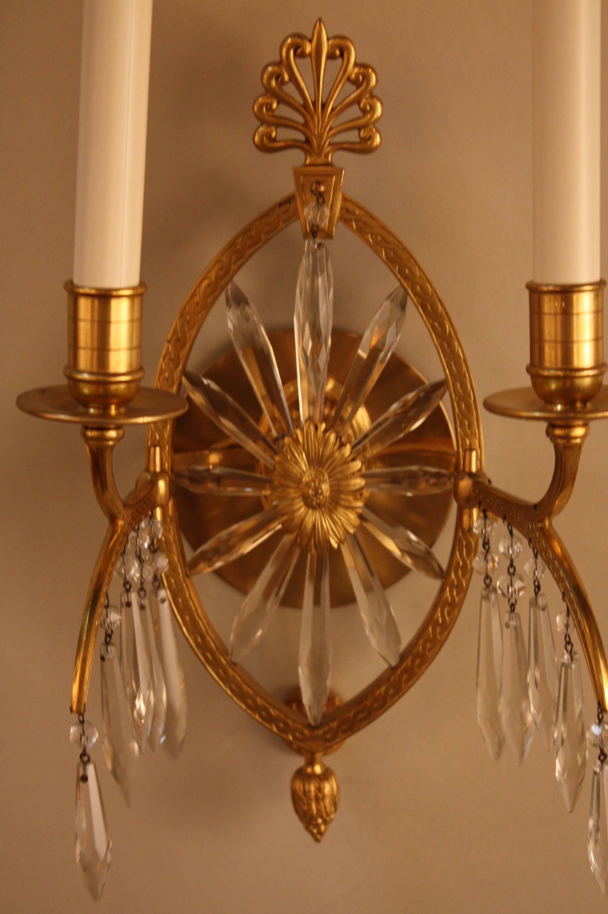 Fabulous set of three late 19th century sunburst crystal and bronze moveable arm piano sconces. they were attached on the piano with candle to illuminating the music note, but this elegant set of wall sconces have been electrified and modified with