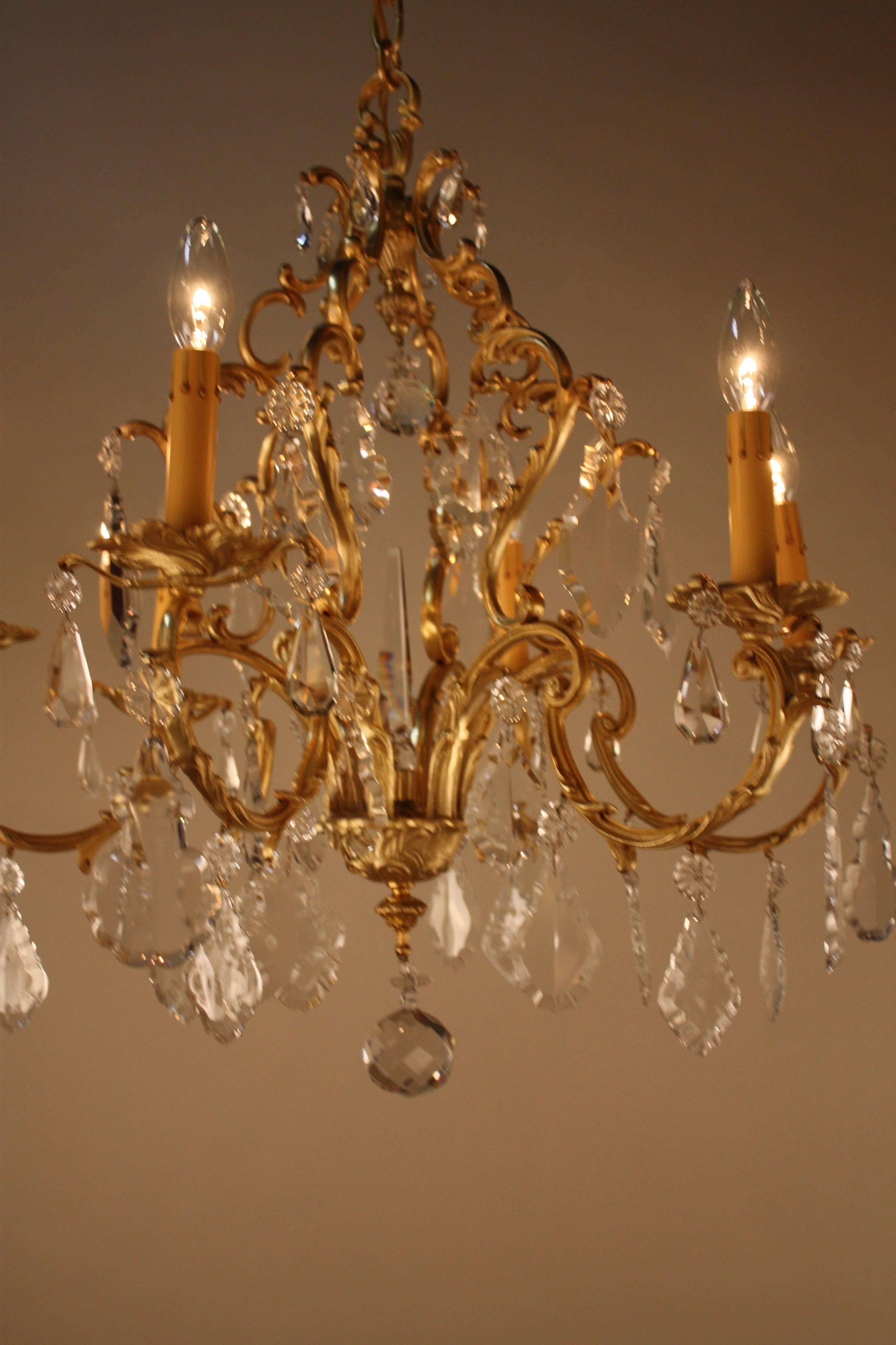 A fabulous six-light crystal and gilt bronze chandelier.
This chandelier is 25