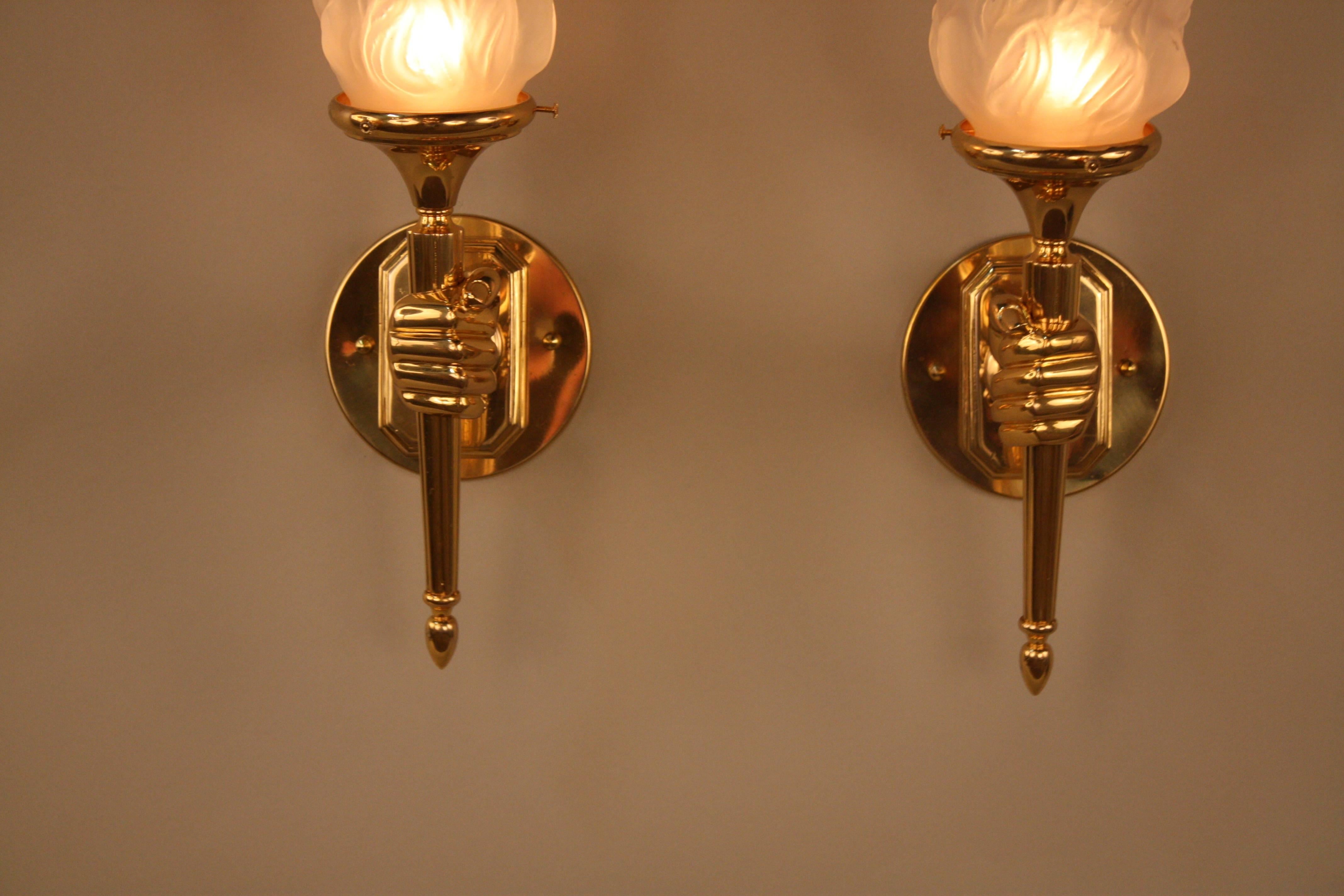 Wonderful pair of polished bronze hand hold torch bronze wall sconces.