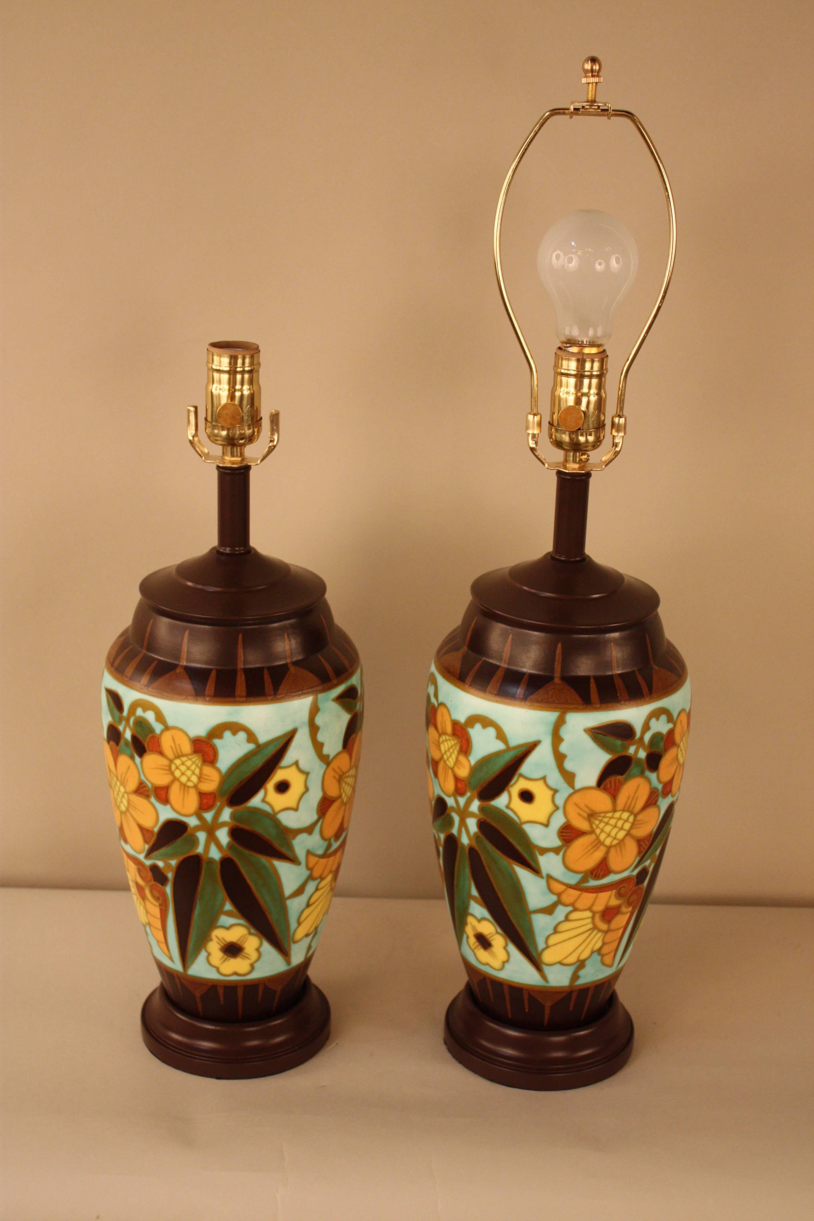 A pair of Art Deco vases that has been customized to beautiful lamps. The wonderful large flora design Art Deco style vases were manufactured by Boch Freres in Belgium.