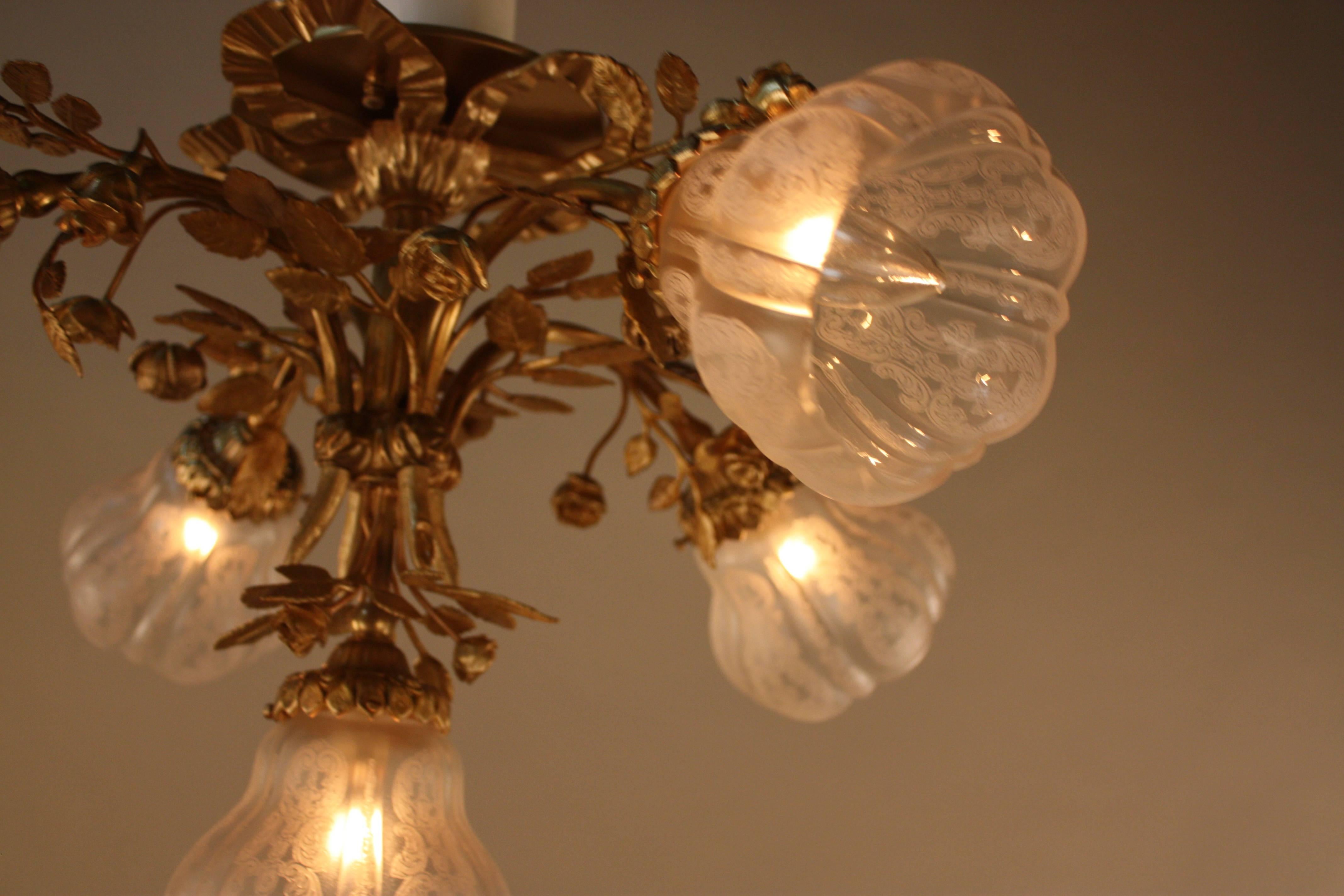 Flora design bronze flush mount chandelier with acid etched glass shades.