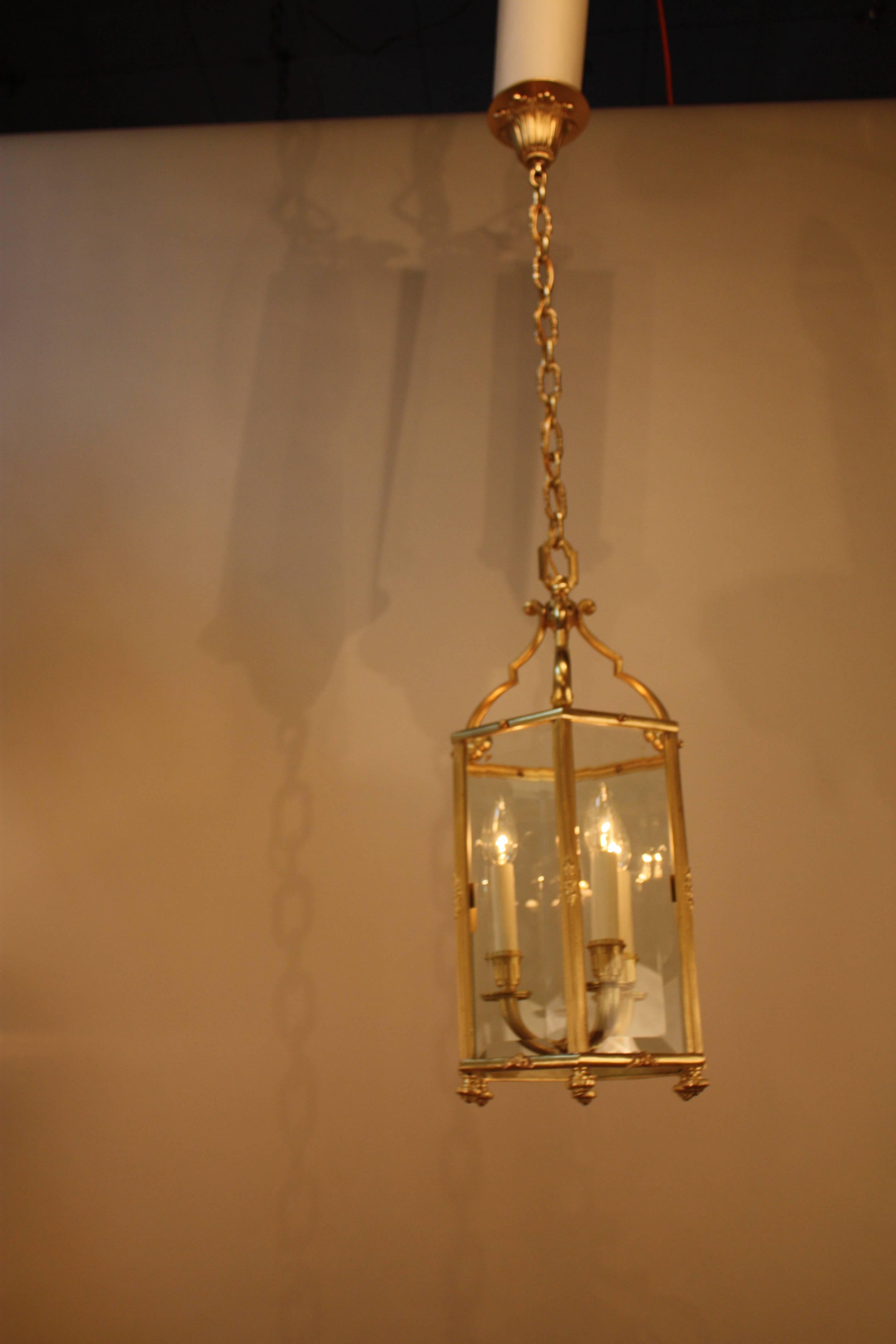 Made in France during the 1930s, this bronze hexagon shape beveled glass lantern is exceptionally beautiful. Three candelabra style lights elegantly illuminate and an absolutely superb fixture.
