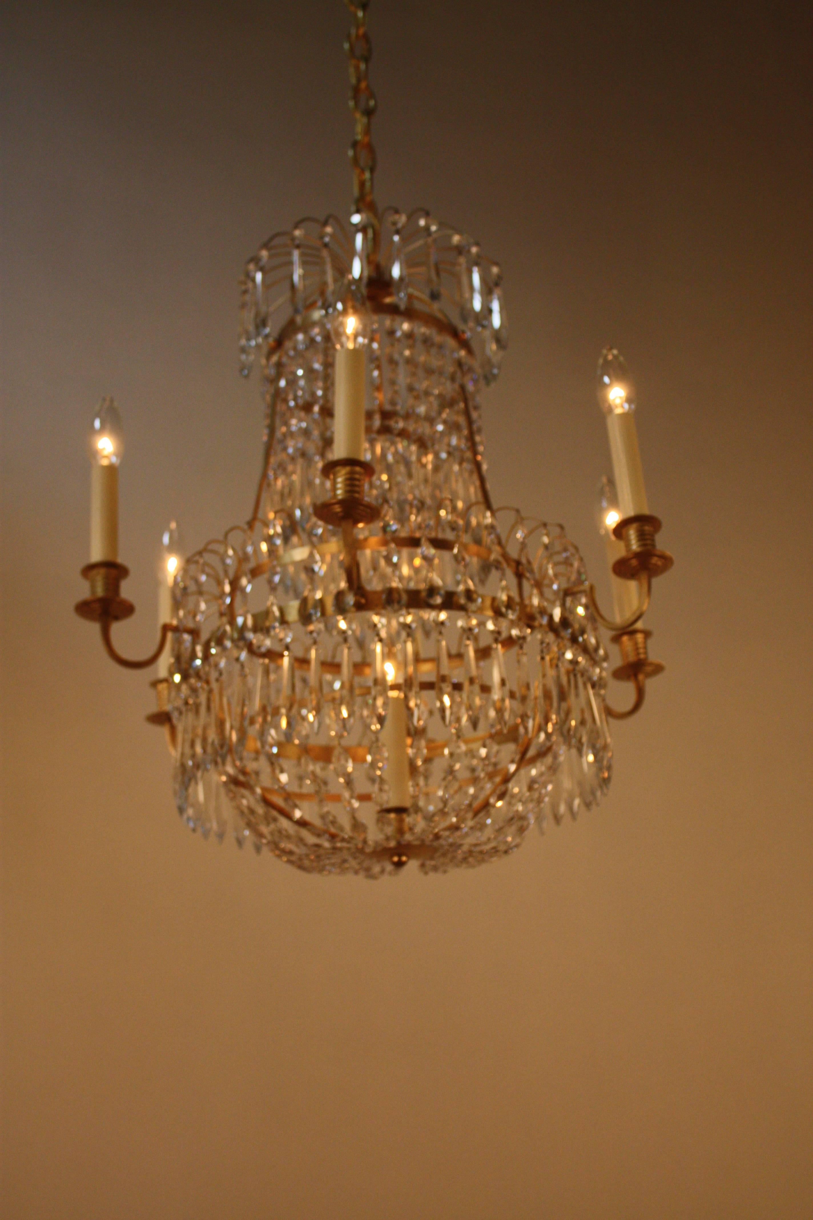 Made in France during the late part of 19th century. Seven-light simple bronze design with graduated crystal chain and faceted crystal drops.
The total height fully installed is 28