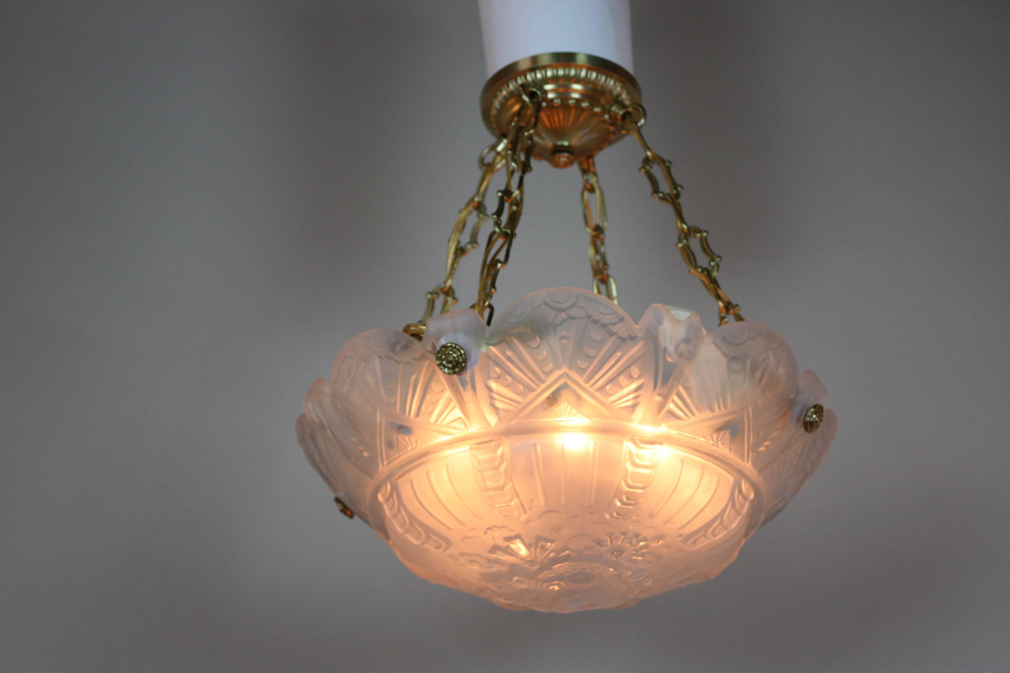 This eight-light Art Deco pendant light was designed and manufactured by the Muller Freres in Luneville, France in the 1930s. This hard to find style glass is very desirable, the glass is frost with clear polish high light and has four pendant