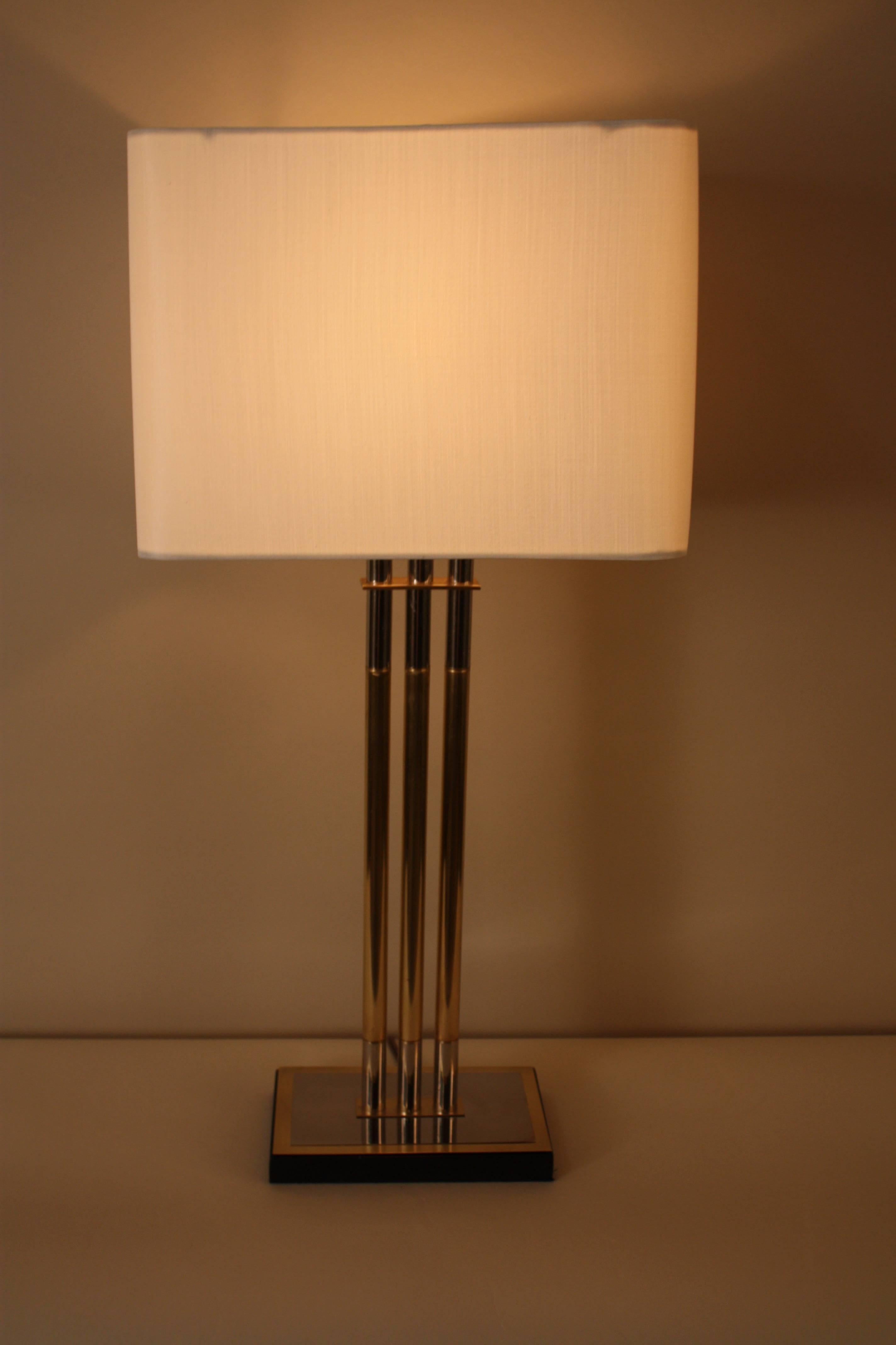 A simple but elegant design table lamp with combination of polished nickel and bronze with a touch of black at base.