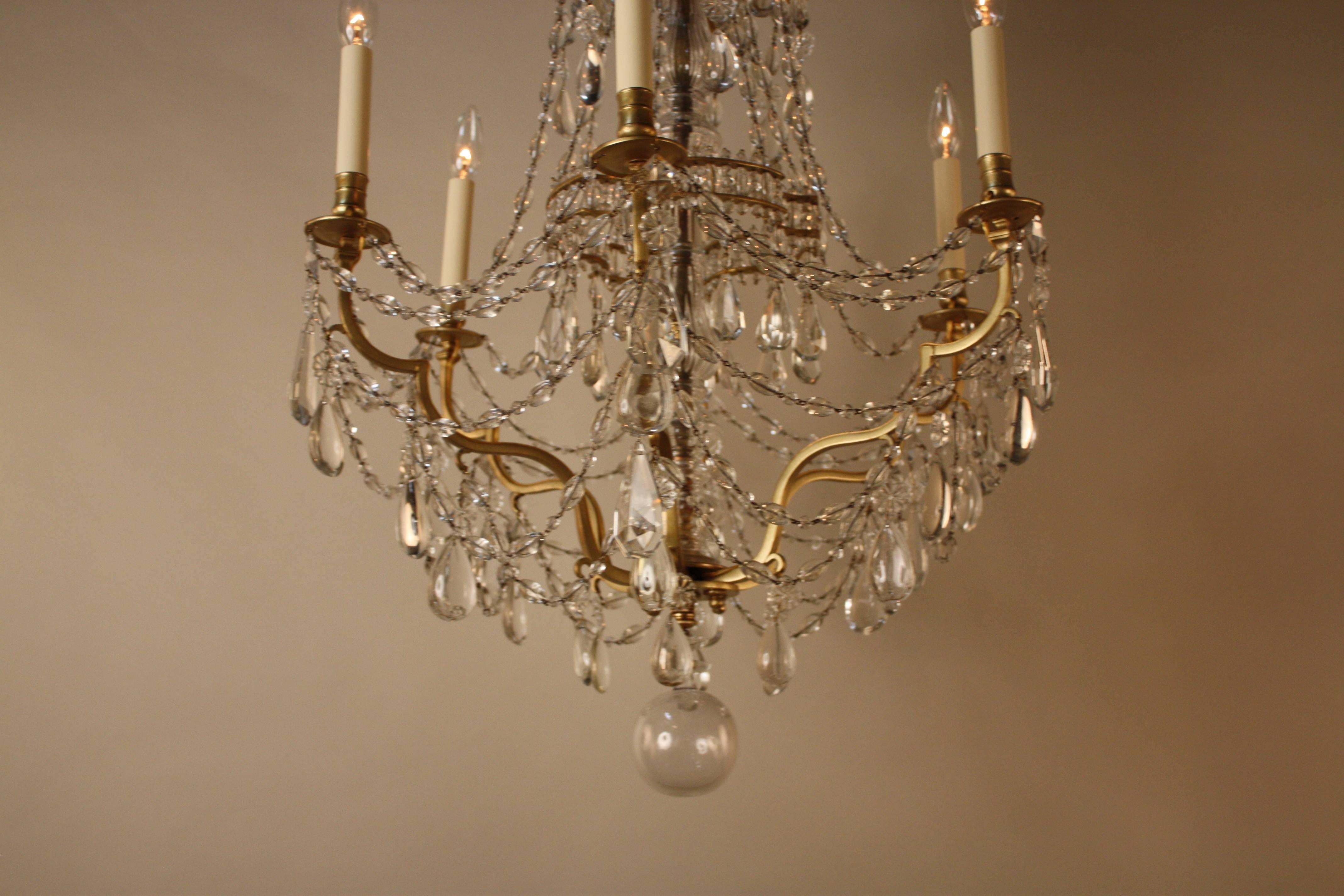 Elegant six-arm chandelier with hand polished olive shape crystal and beautiful design bronze frame work. This chandelier was made in France, early 20th century.
23