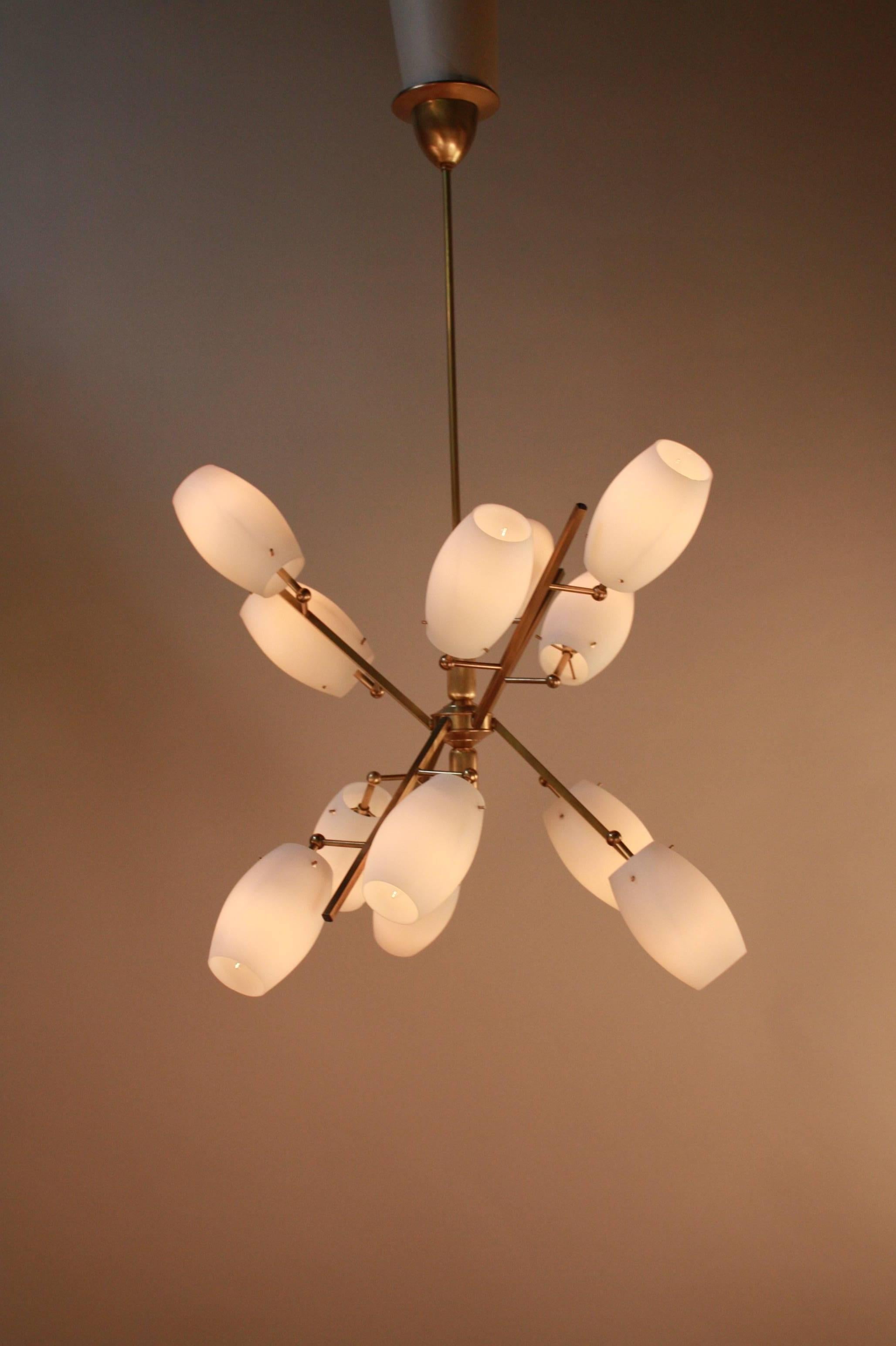 A prefect touch of Italian Mid-Century chandelier. Finished in satin bronze with 12 white opal glass.