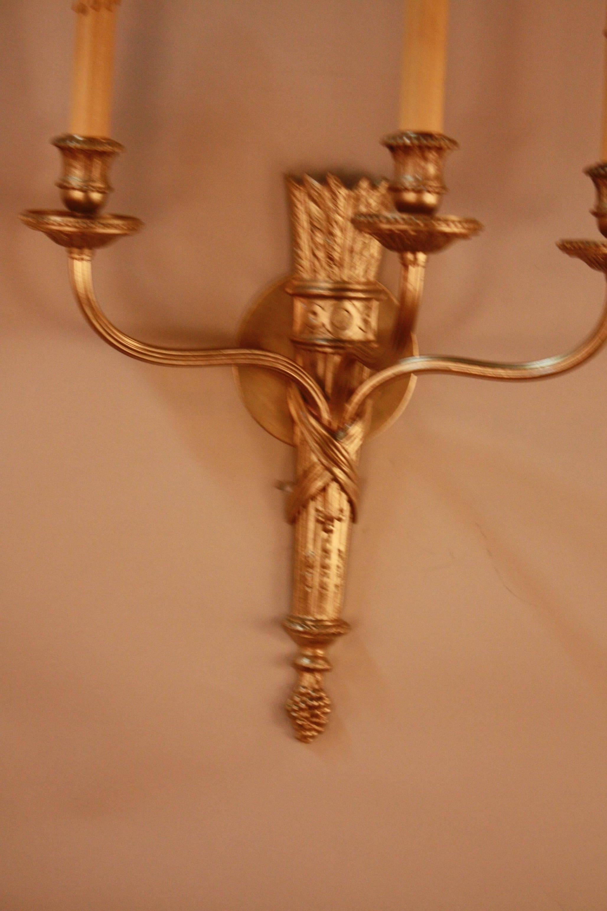 Elegant three-candle light French Empire bronze wall sconces.