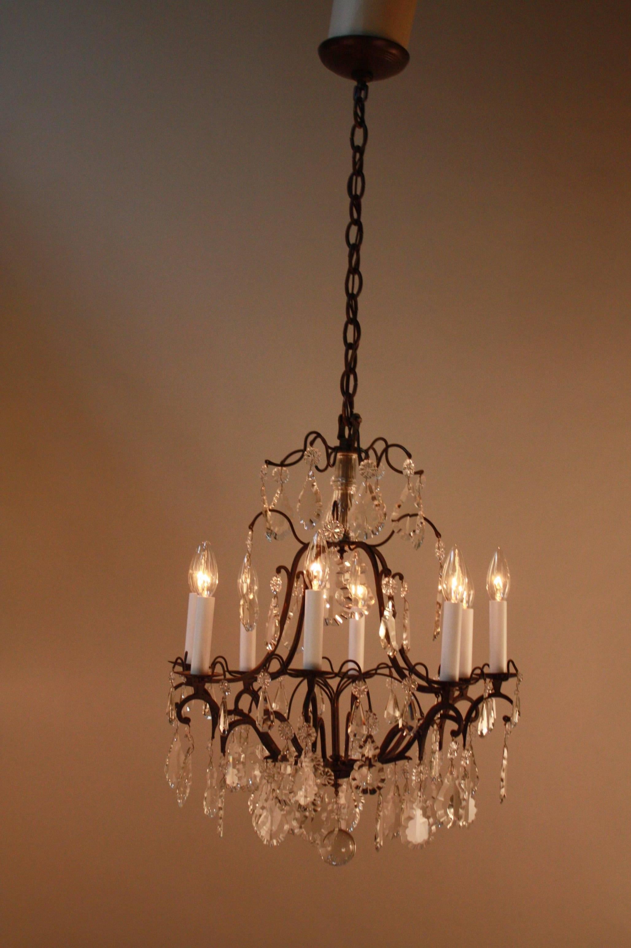 Elegant nine-light 1930s crystal and bronze chandelier.