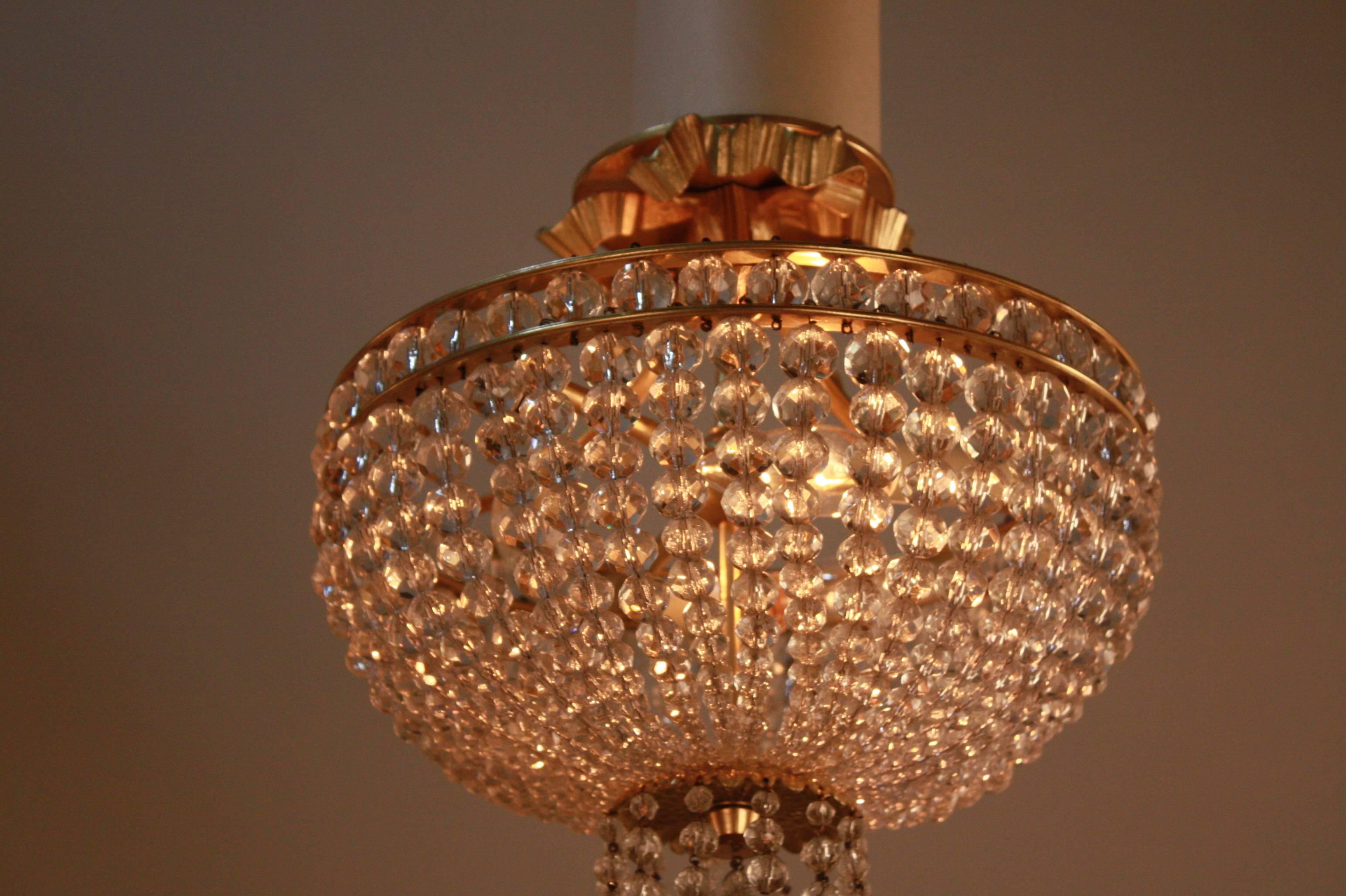 Wonderful three-light crystal basket semi flush mount chandelier with bronze frame and canopy.