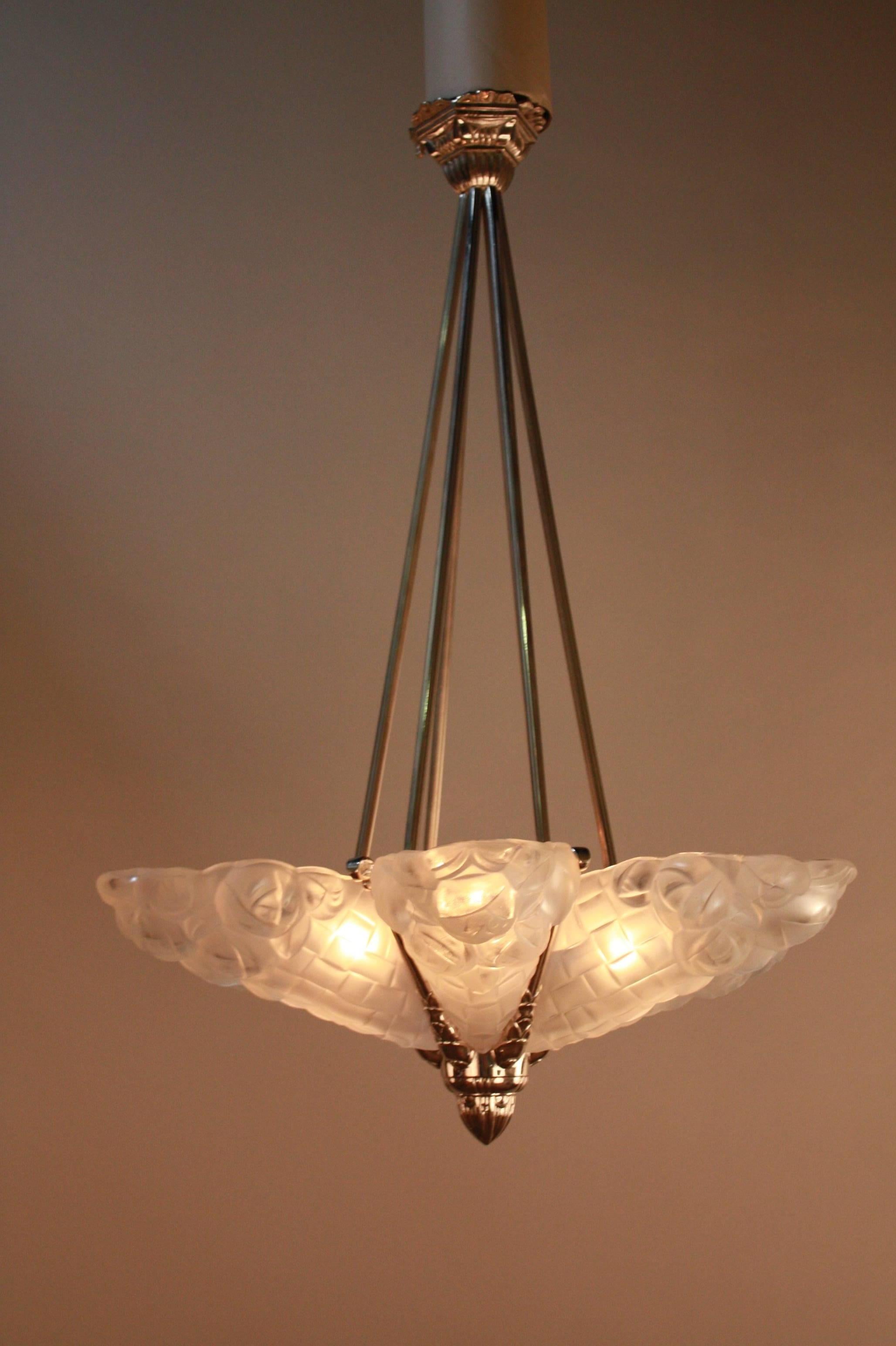 A stunning Art Deco chandelier. Crafted in France, this chandelier features six glass panels with beautiful detail work. The hardware is fantastic nickel on bronze. The chandelier measures 25