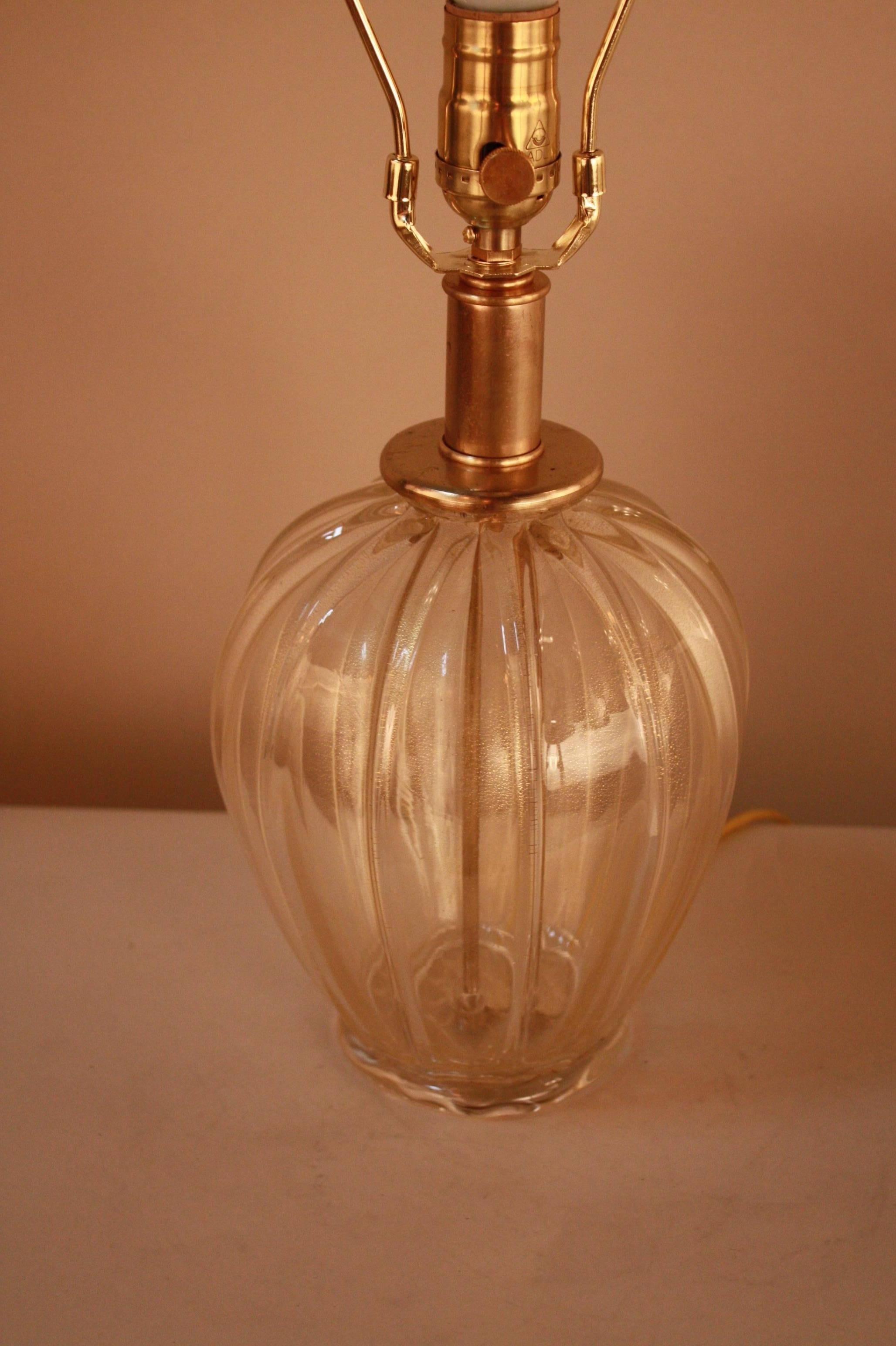 A fantastic petite blown glass lamp in clear with touch of gold by Moreau Freres.
This lamp is fitted with hardback silk lampshade.