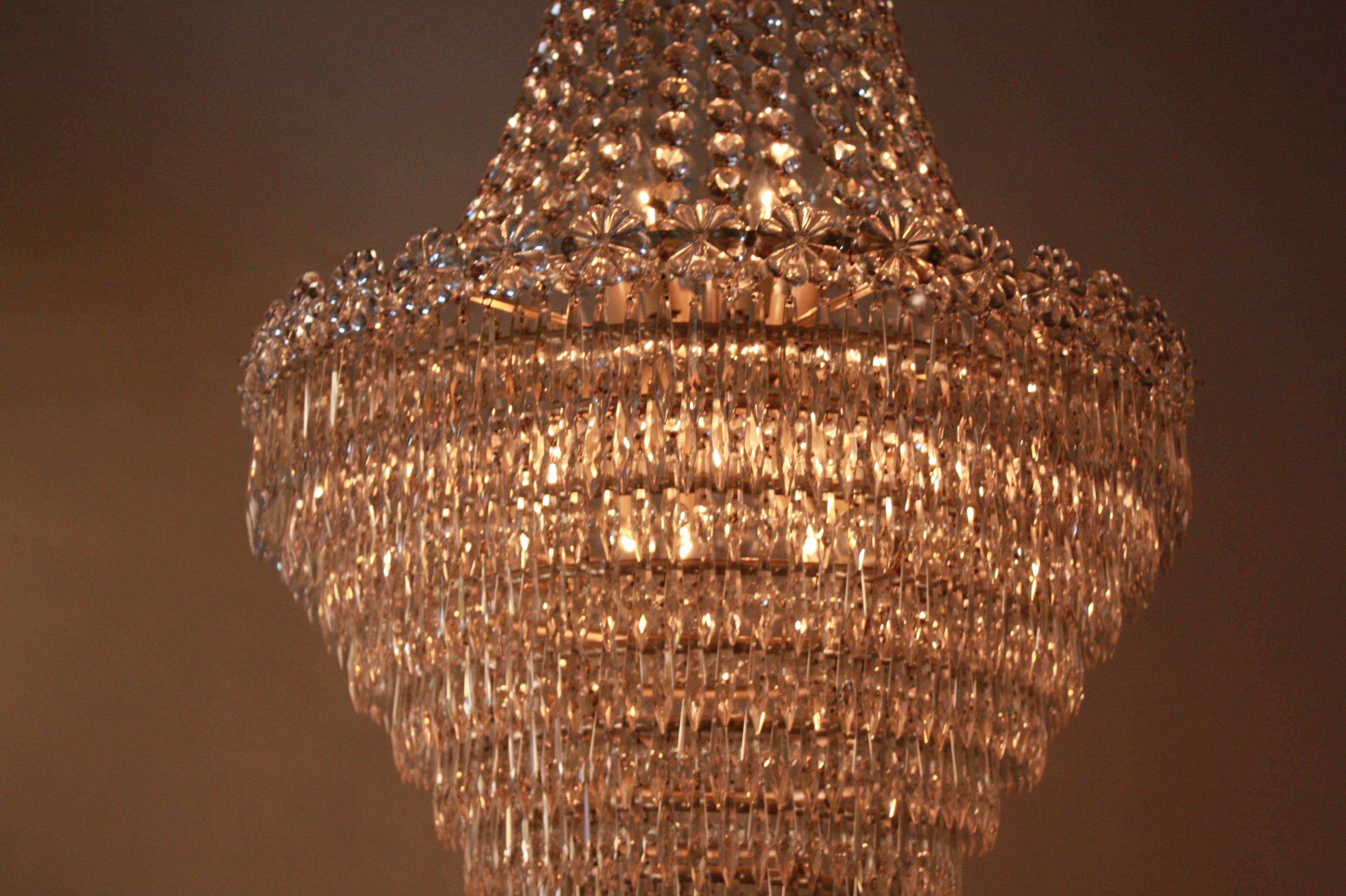 Dazzling Empire style 18 light crystal chandelier. Made in Spain in 1930s with hundreds of sparking crystal.
Satin nickel on bronze chain and canopy.
Measures: 42