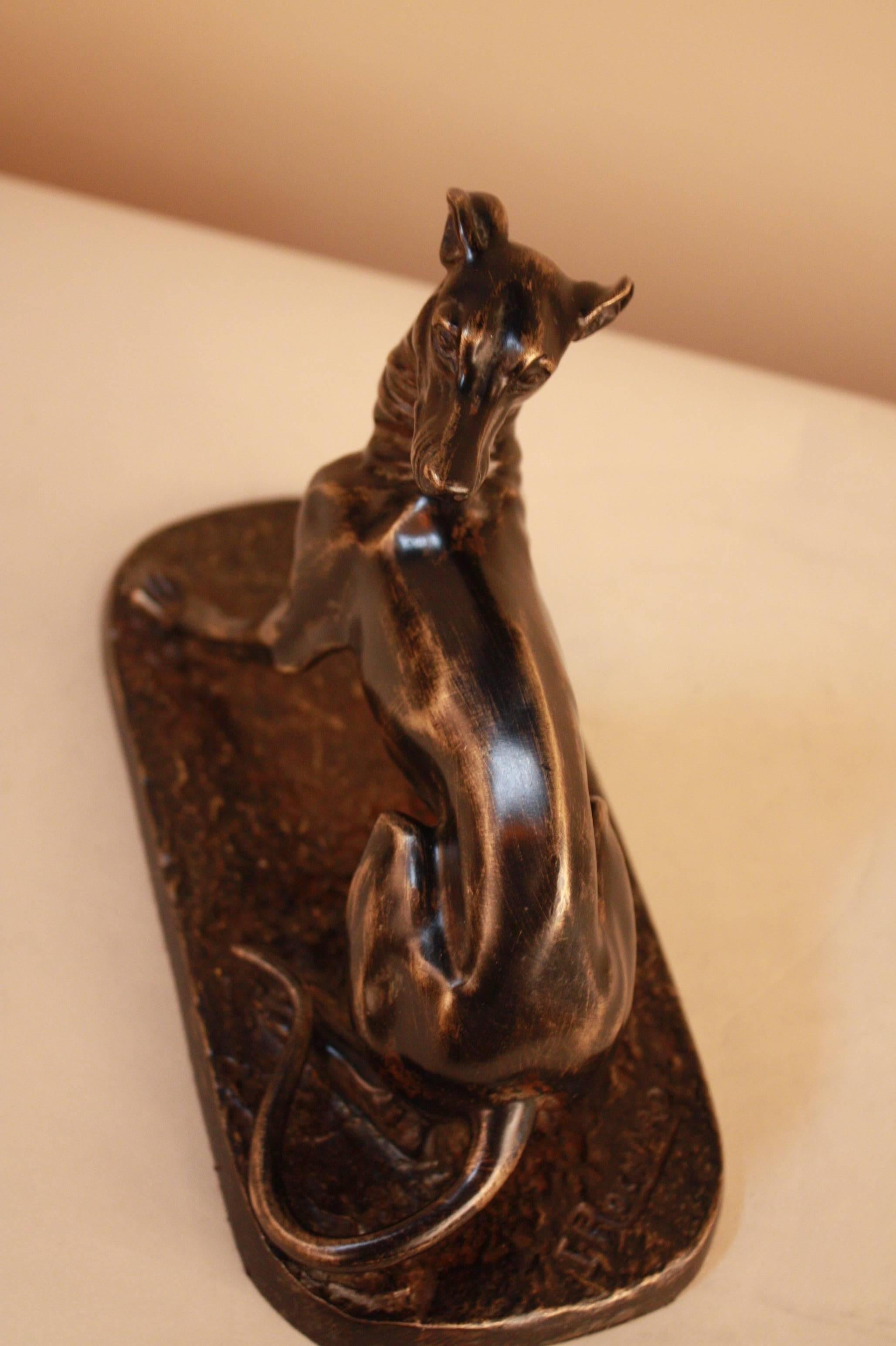 A 1930s greyhound dog in black patina bronze by famed French animal sculptor Irenee Rochard. Features her signature in the rear of the piece, see image four. 