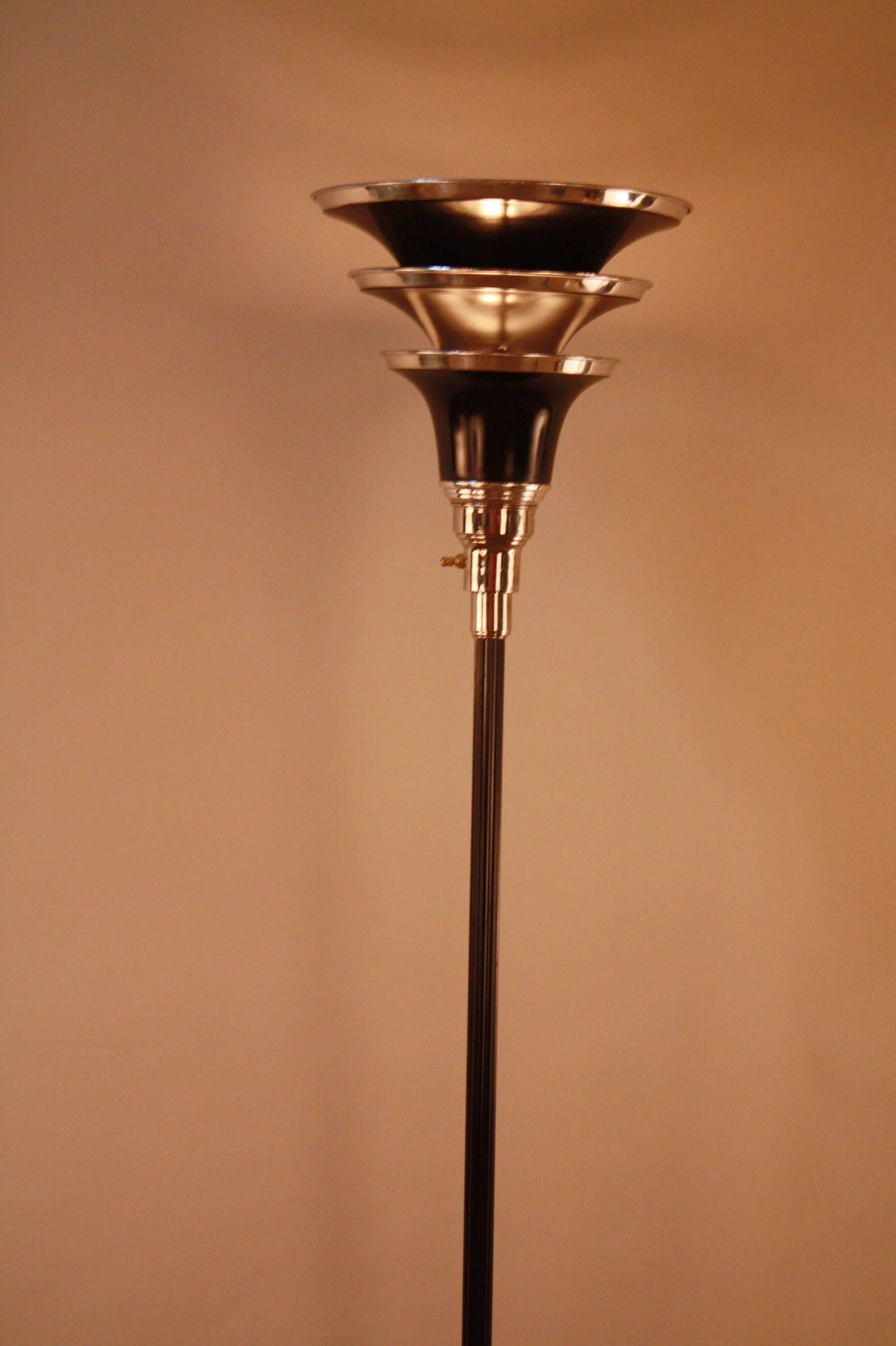 A three tear shade American Art Deco floor lamp in polished chrome, black lacquer satin aluminum.