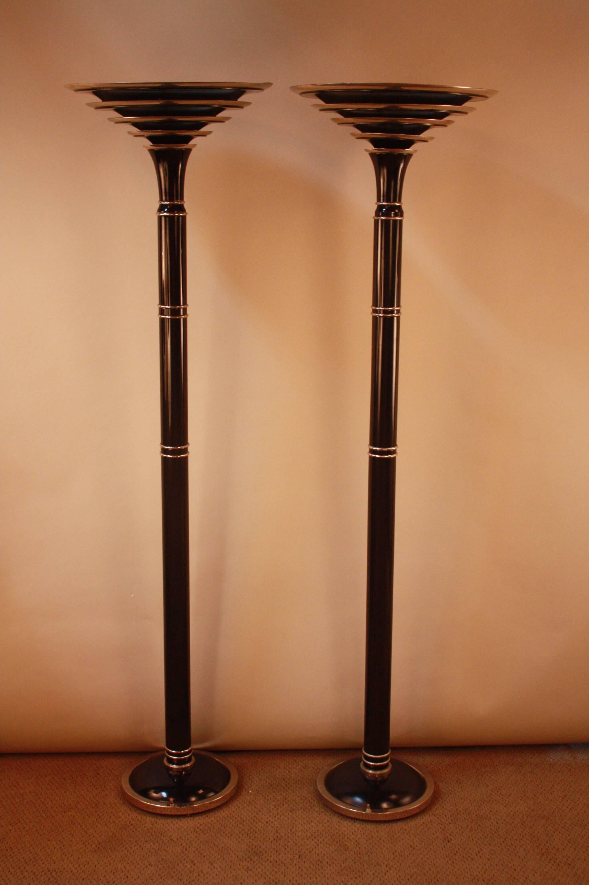 A pair of four-tier shade French floor lamps made of nickel and black lacquer. The dark color and sleek silhouette brings the viewer to the period of Art Deco, in pre-World War I France. A truly beautiful piece for its time, this pair will bring