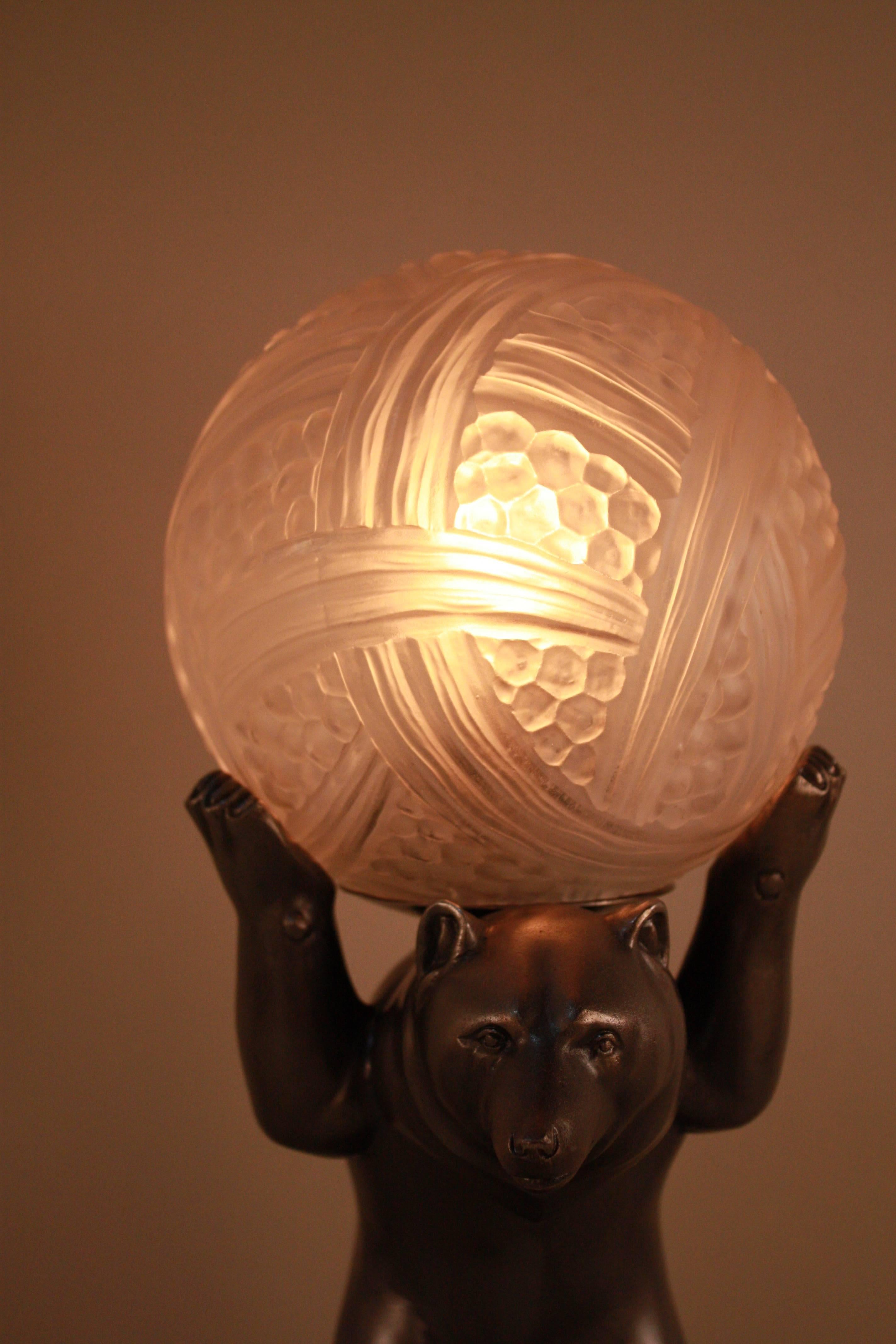 A stunning pewter bear base with beautiful geometric design glass shade by Hettier & Vincent.