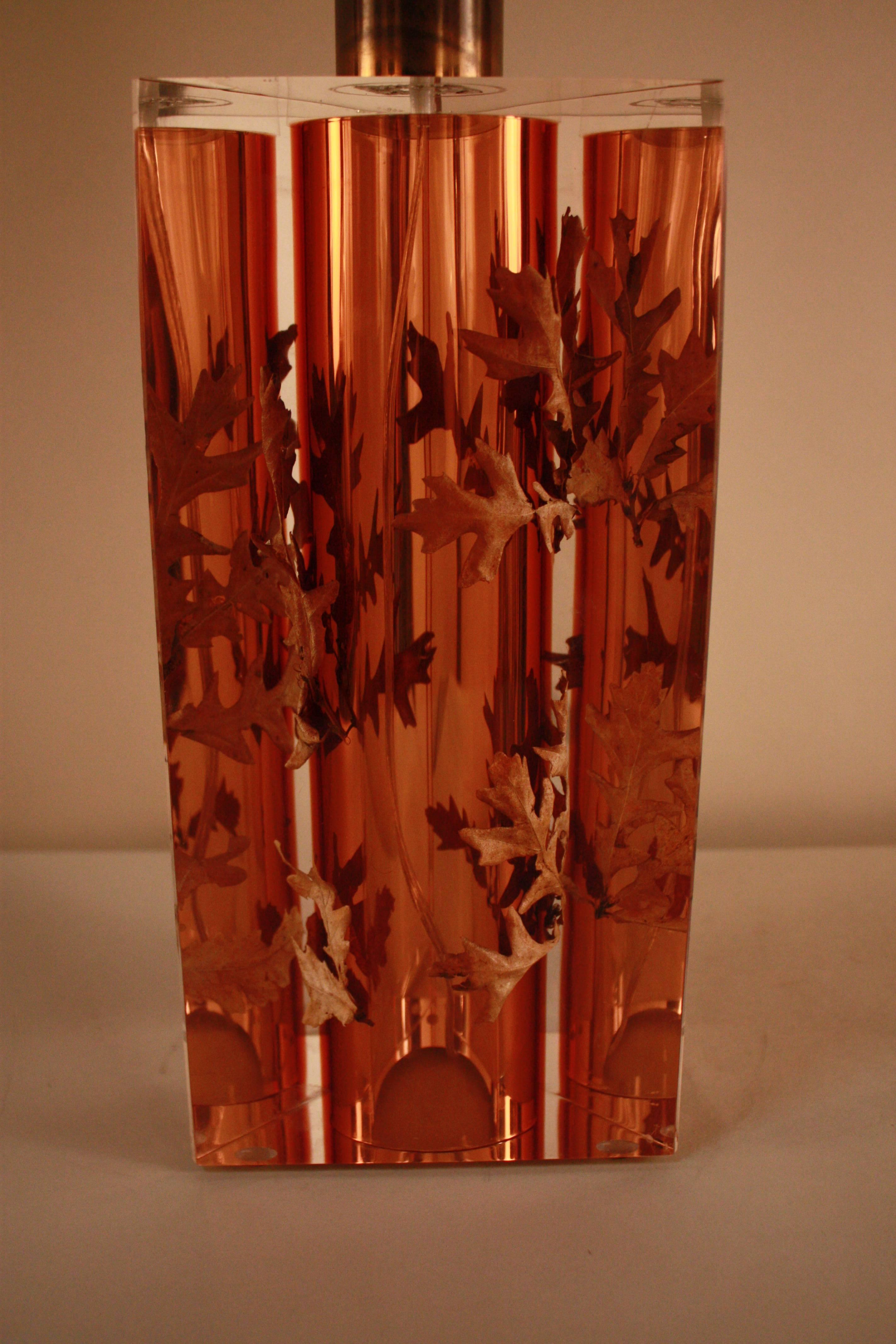 A fantastic peach color Lucite table lamp. Inspired by Marie Claude de Fouquieres by inserting objects in Lucite, rare and beautiful lamp.