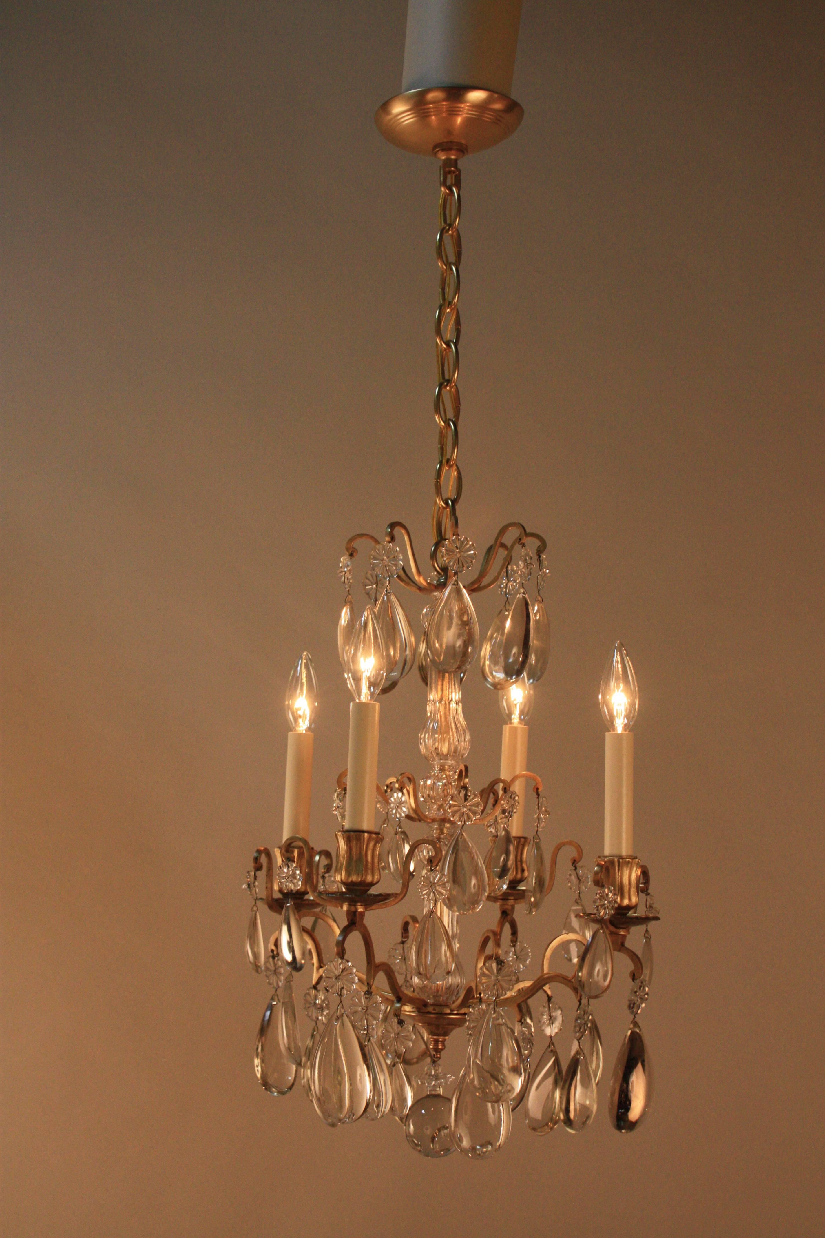 A fabulous four-light bronze chandelier with half pear wood polish crystal.