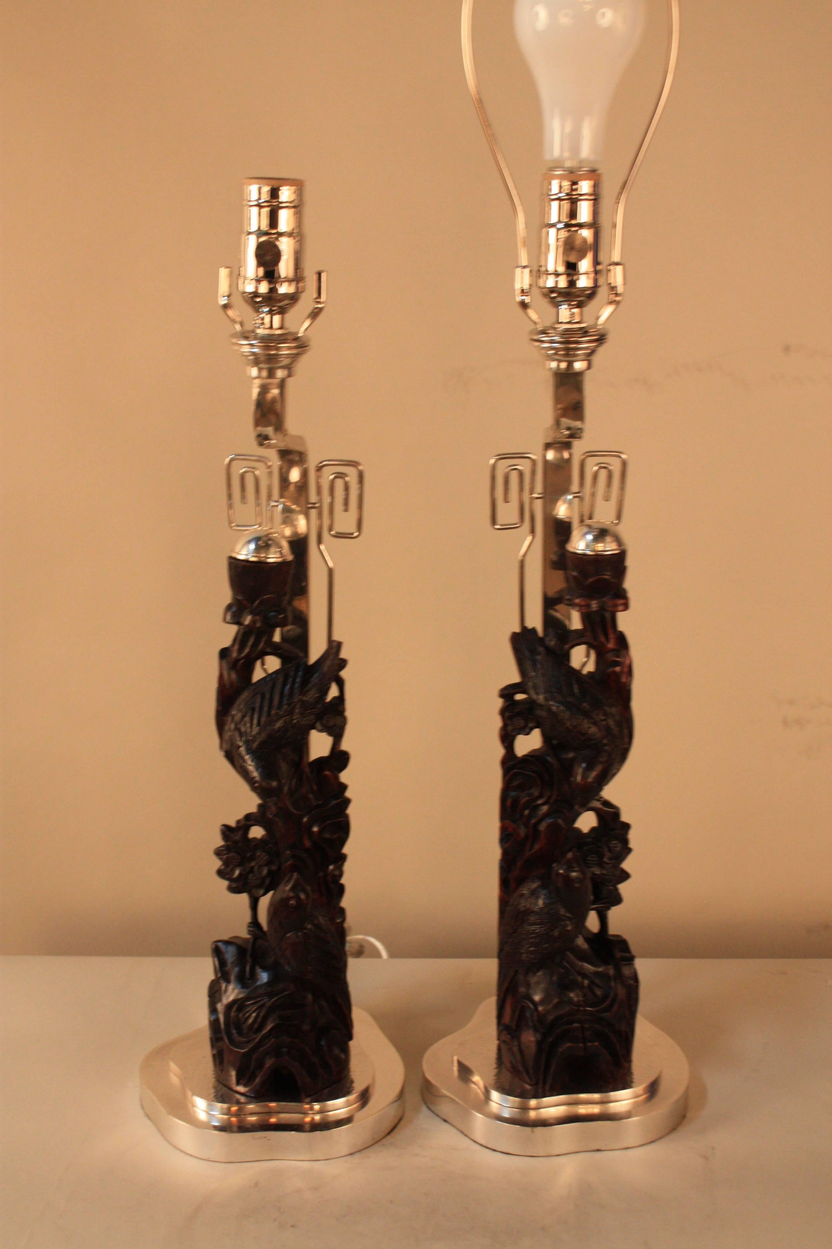 Pair of 19th century beautifully hand-carved rosewood Chinese candlestick that have been customized to table lamp during 1950s with silver on bronze bases.
19th century Chinese candlestick, lamp base France, 1950s.