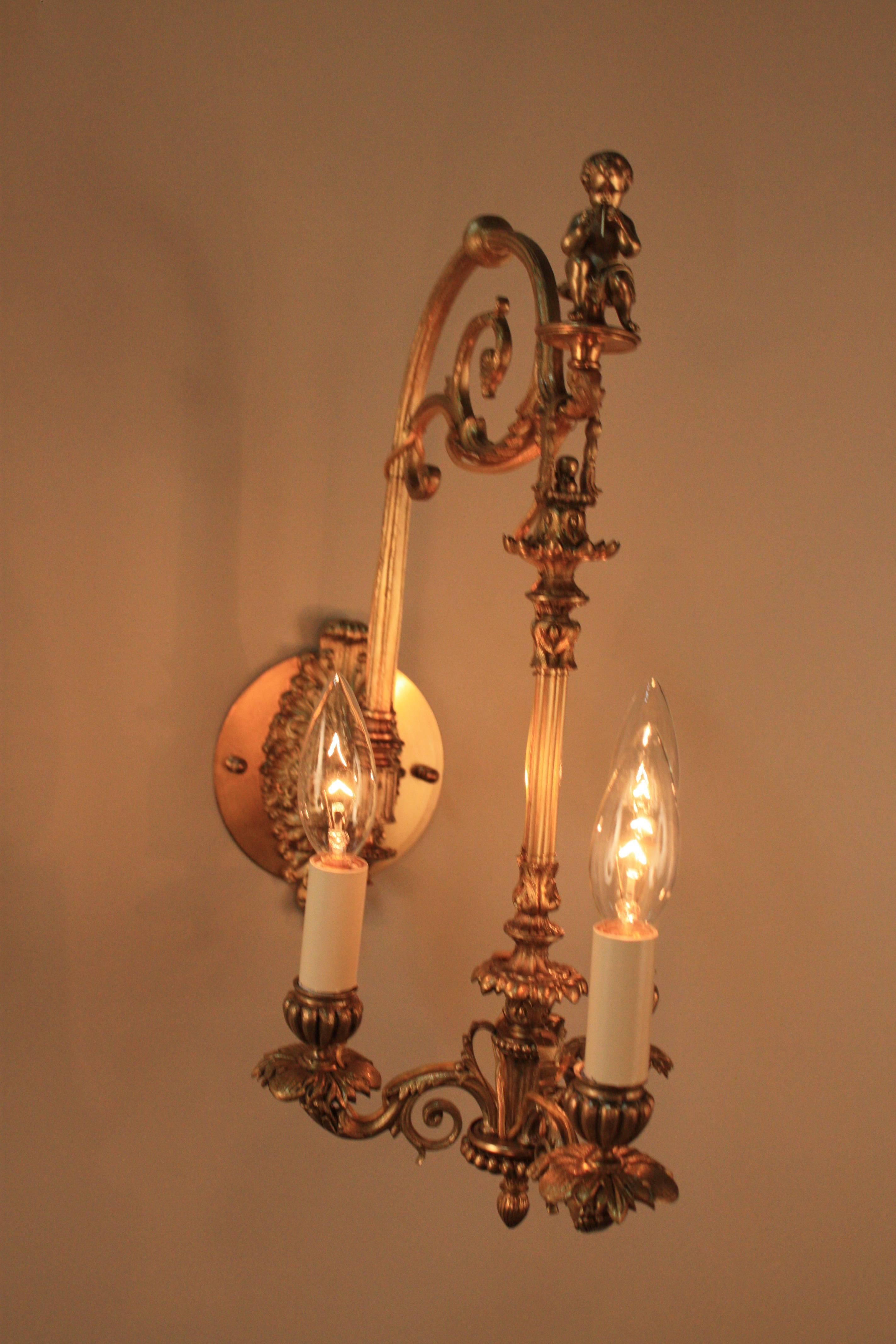 Elegant pair of 19th century three-arm candelabra wall sconces that hangs on sculptured wall brackets.