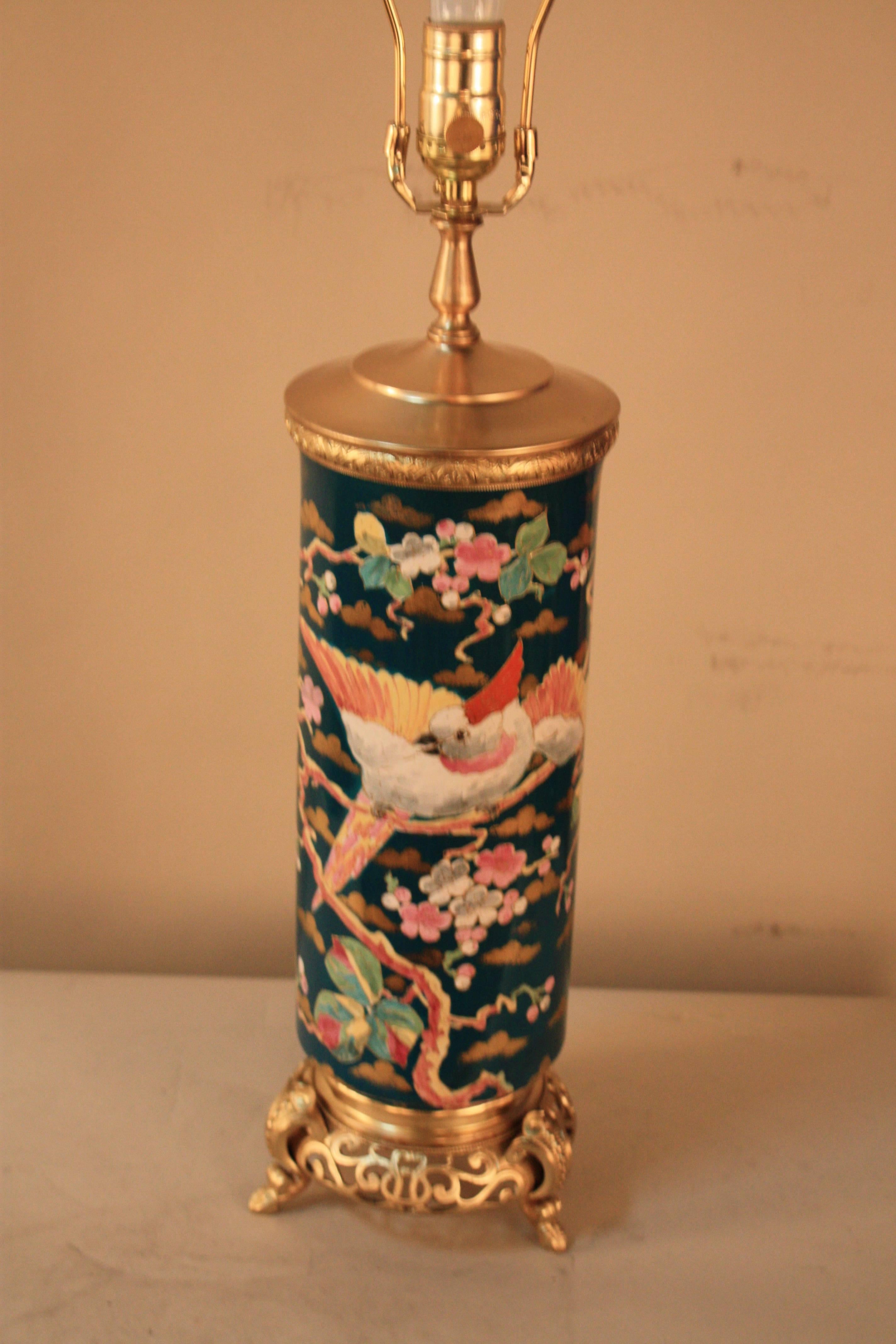 Hand-painted porcelain influenced by Japanese art. This 19th century oil lamp has been modified and electrified as a beautiful table lamp and fitted with silk lampshade.