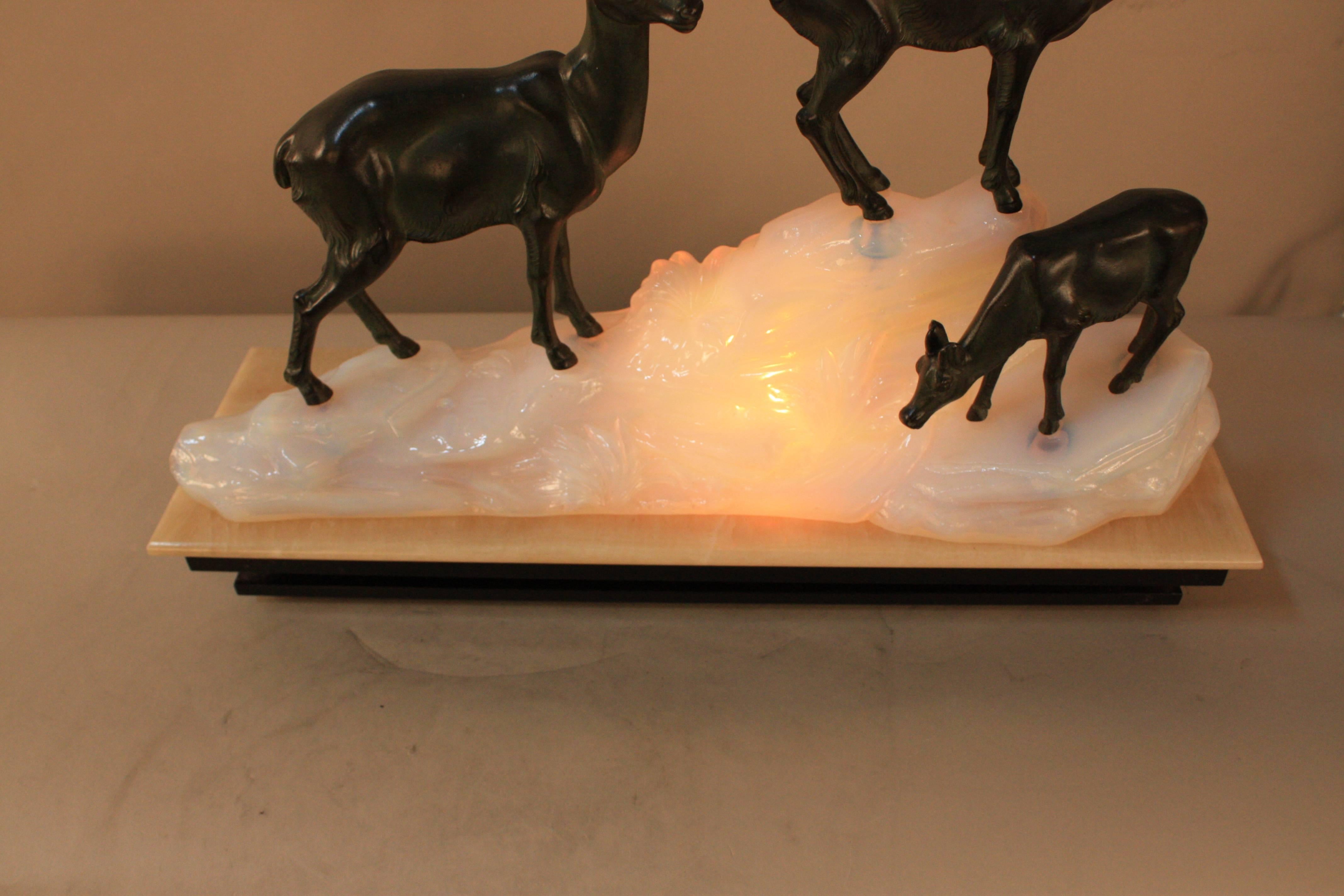 A sculpture lamp, goats on the opalescent glass in shape of mountain on beige and black onyx.