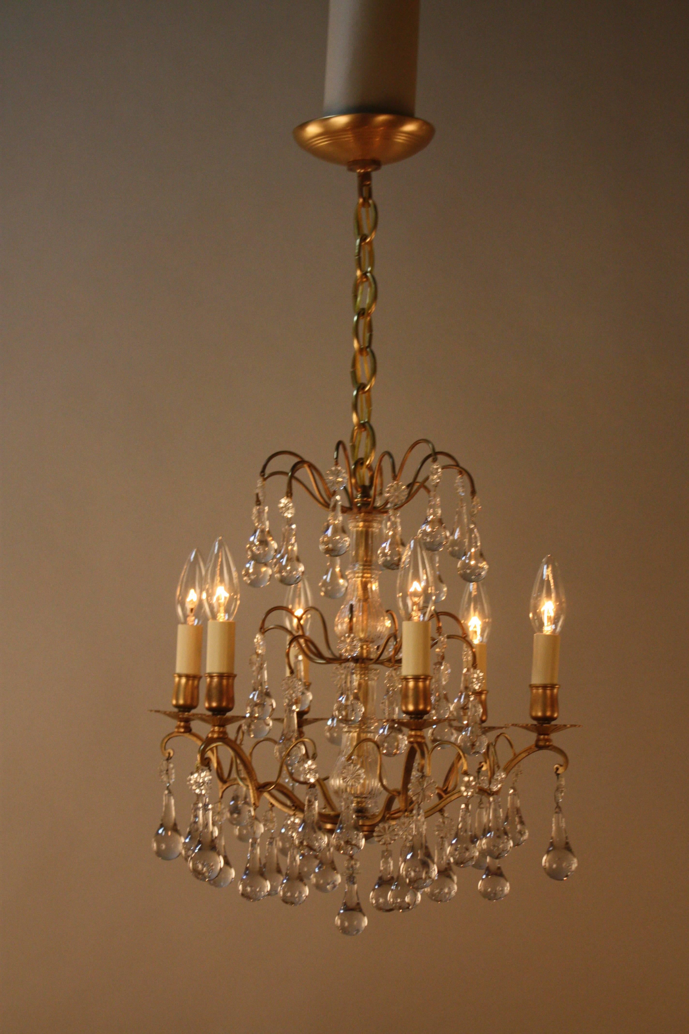 Elegant six-light bronze chandelier with rain drop crystal.
Height: Fully installed with one link of chain and canopy 21