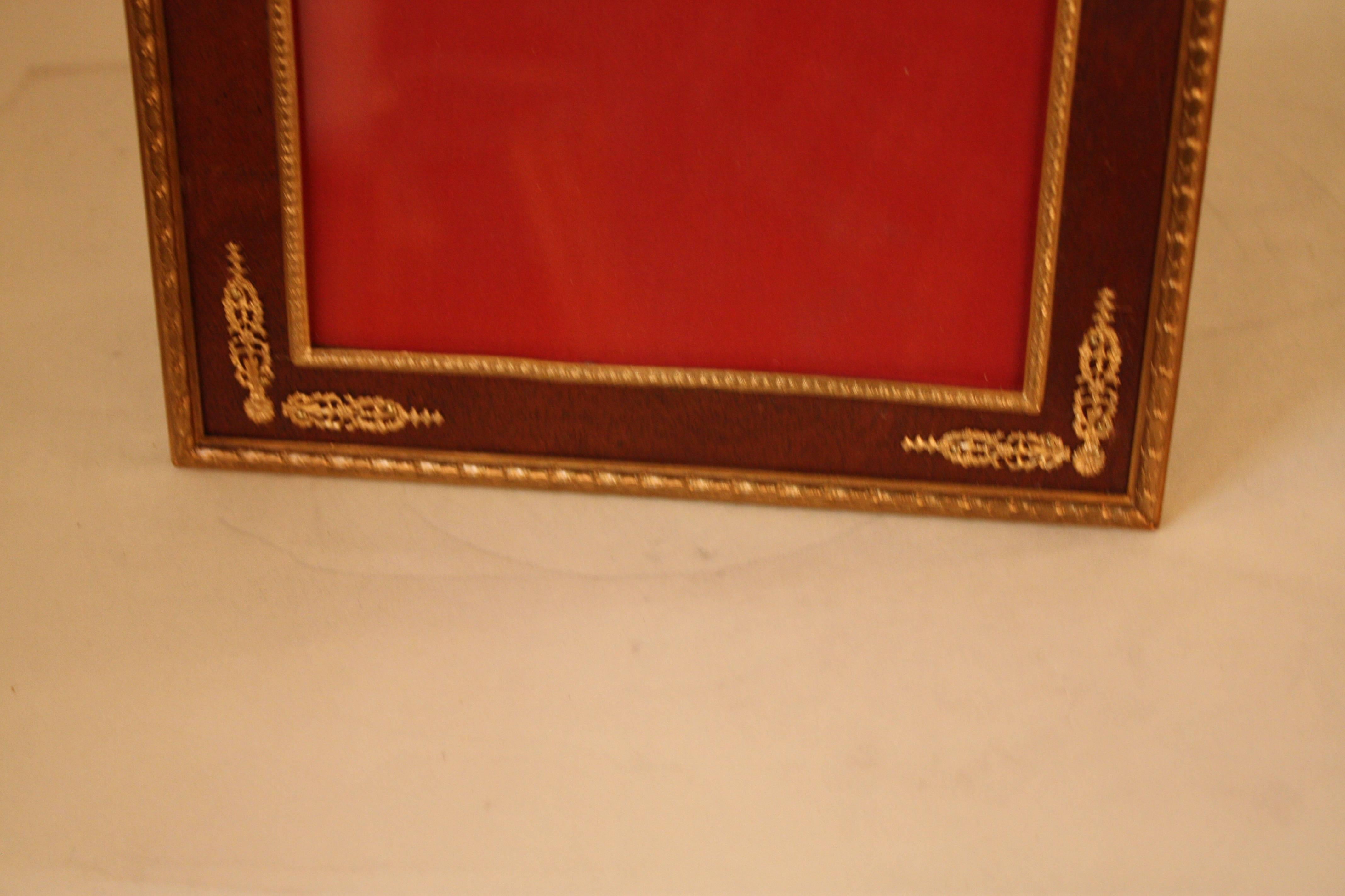 Elegant 19th century French Empire style bronze picture frame with wood trim and a variety of classical bronze-mounted decoration.
Picture size 6.5