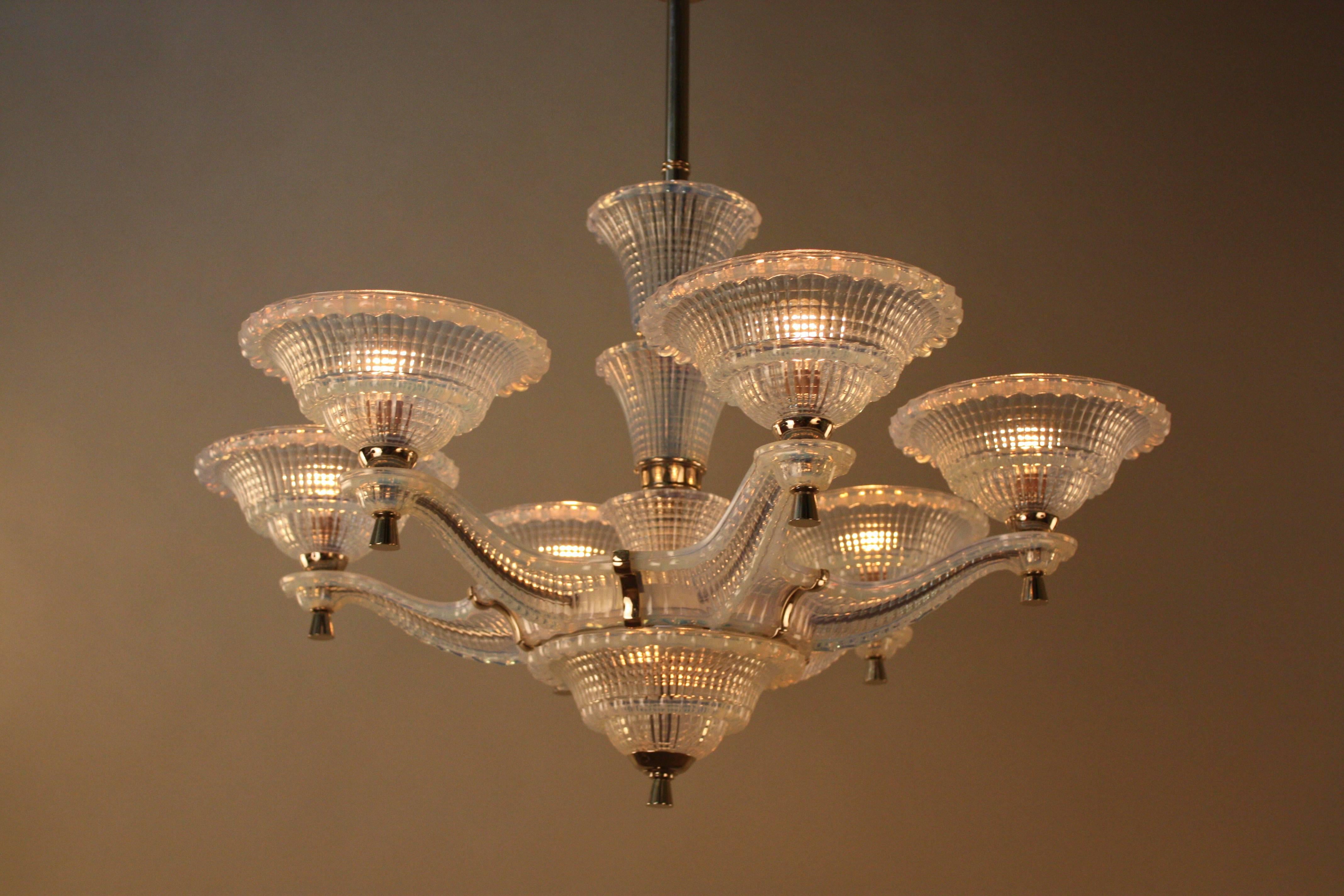An stunning Art Deco chandelier. Made during 1930s this six-arm eight-light chandelier is entirely made of opalescent glass except some nickel on bronze hardware and canopy.
60 watt max each light.