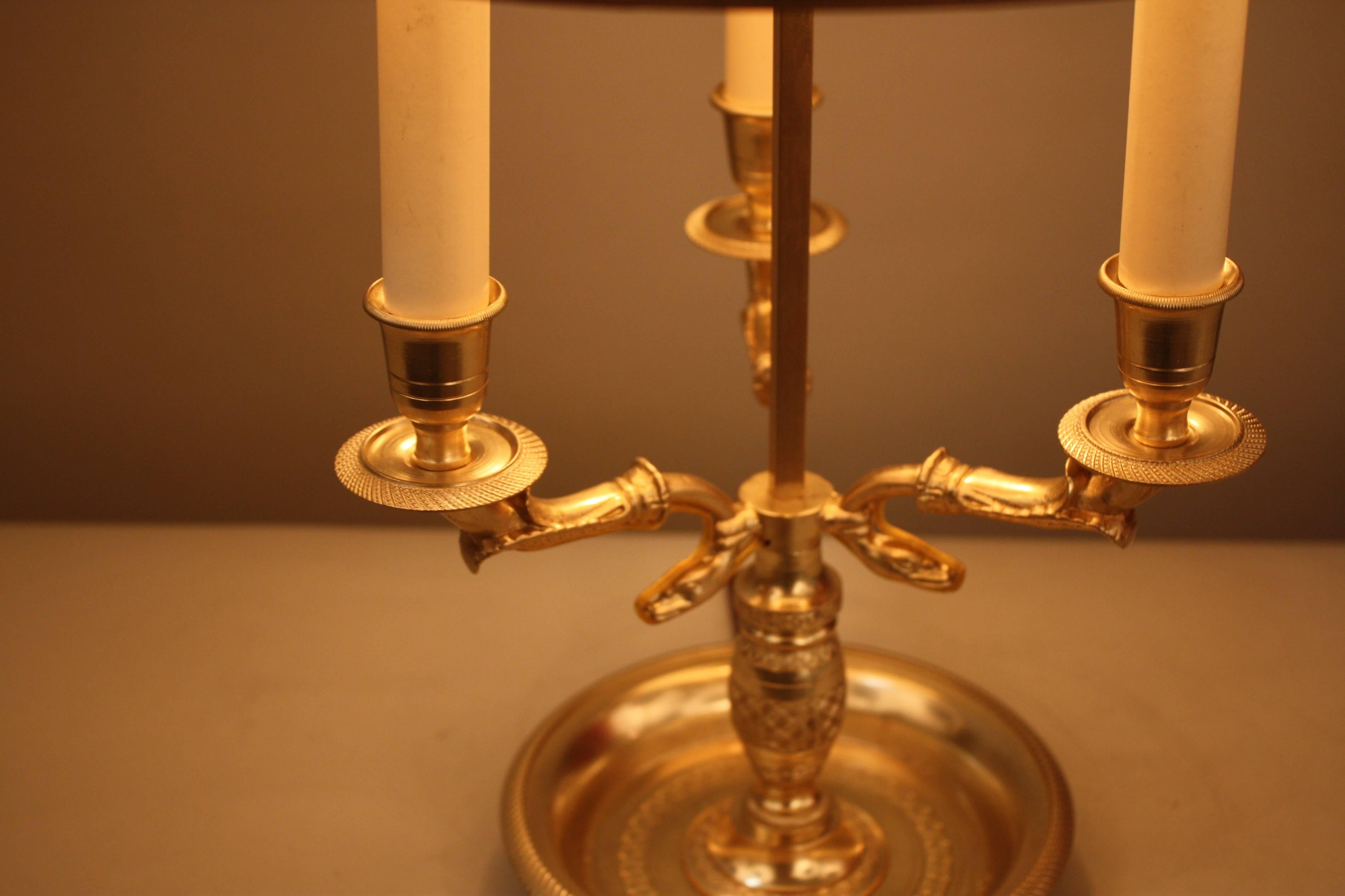 French Empire style three-light bronze table lamp with dark green metal lampshade.
60watt each light.
