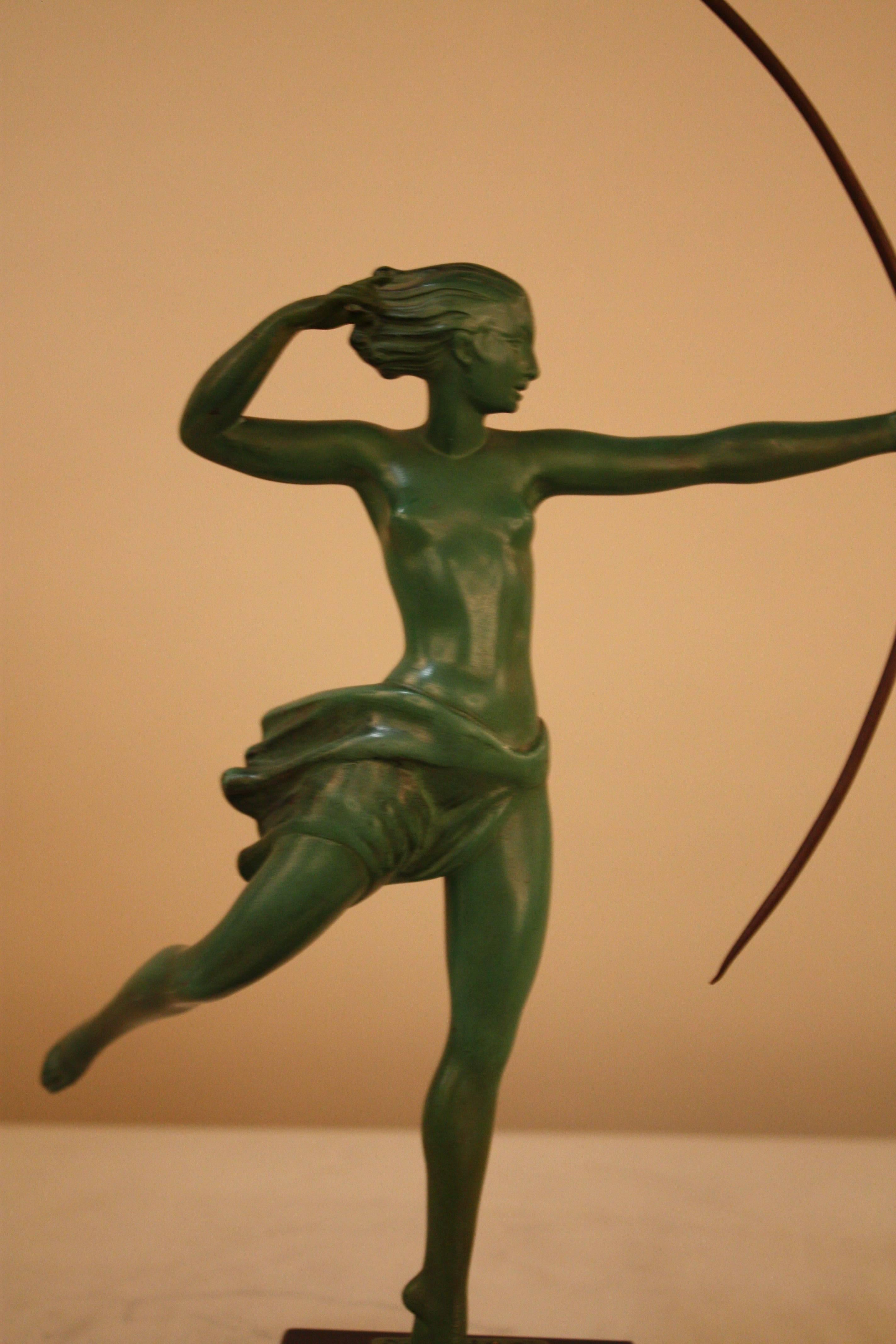 Sculpture of nude woman hunter in beautiful Green patinated by De Marco.
       