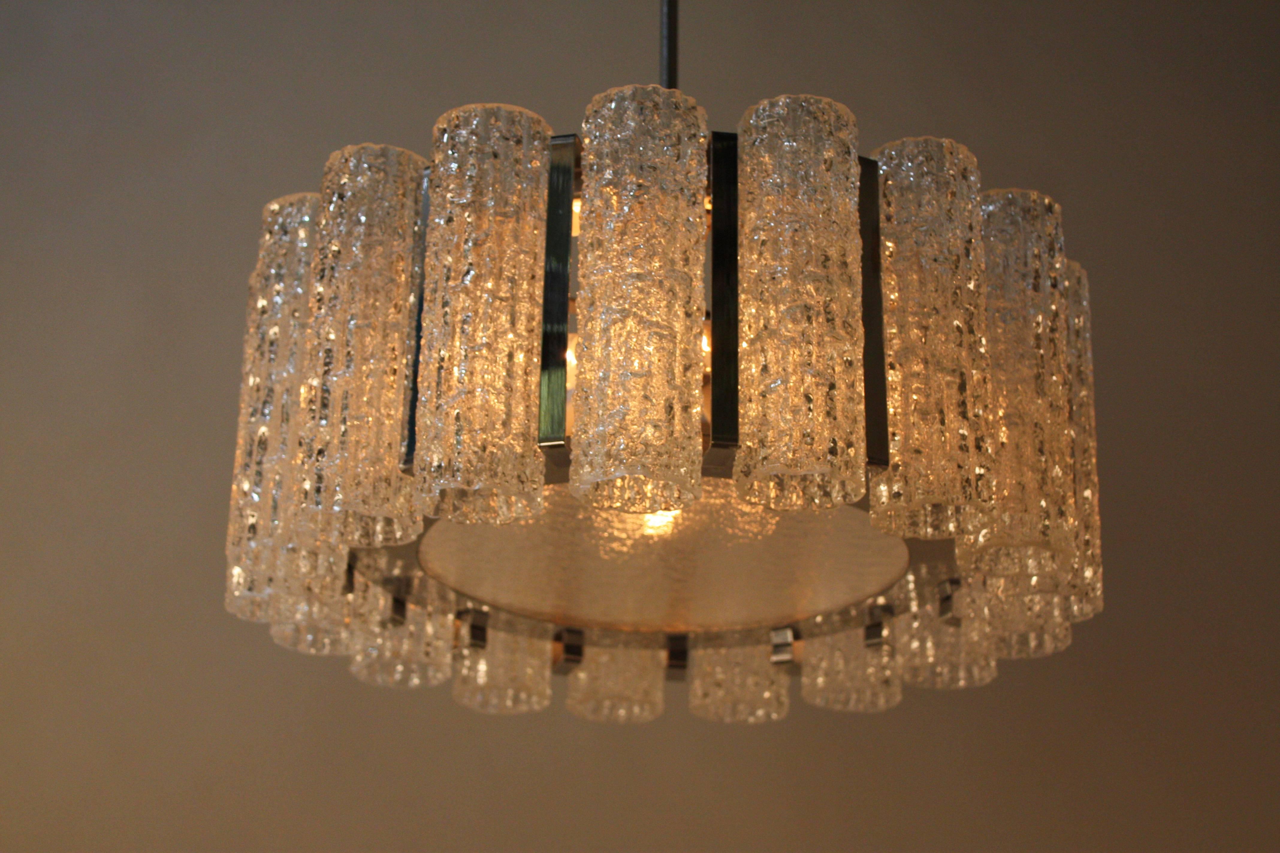 Simple but elegant modern 1970s nine-light texture glass and chrome chandelier.