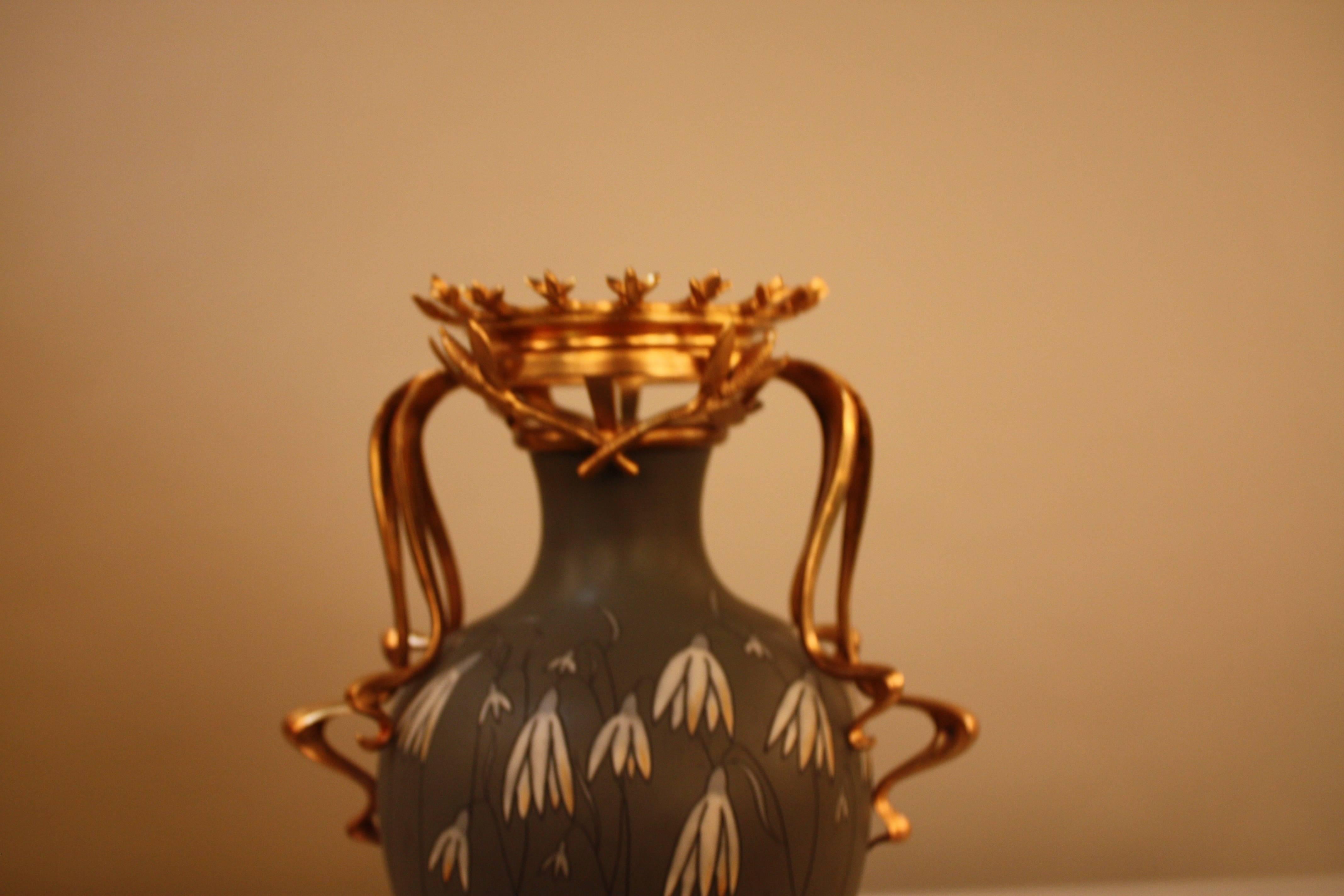 This beautiful urn was crafted in Germany near the turn of the last century. Art Nouveau styled piece, it is decorated with a bronze doré base and handles.