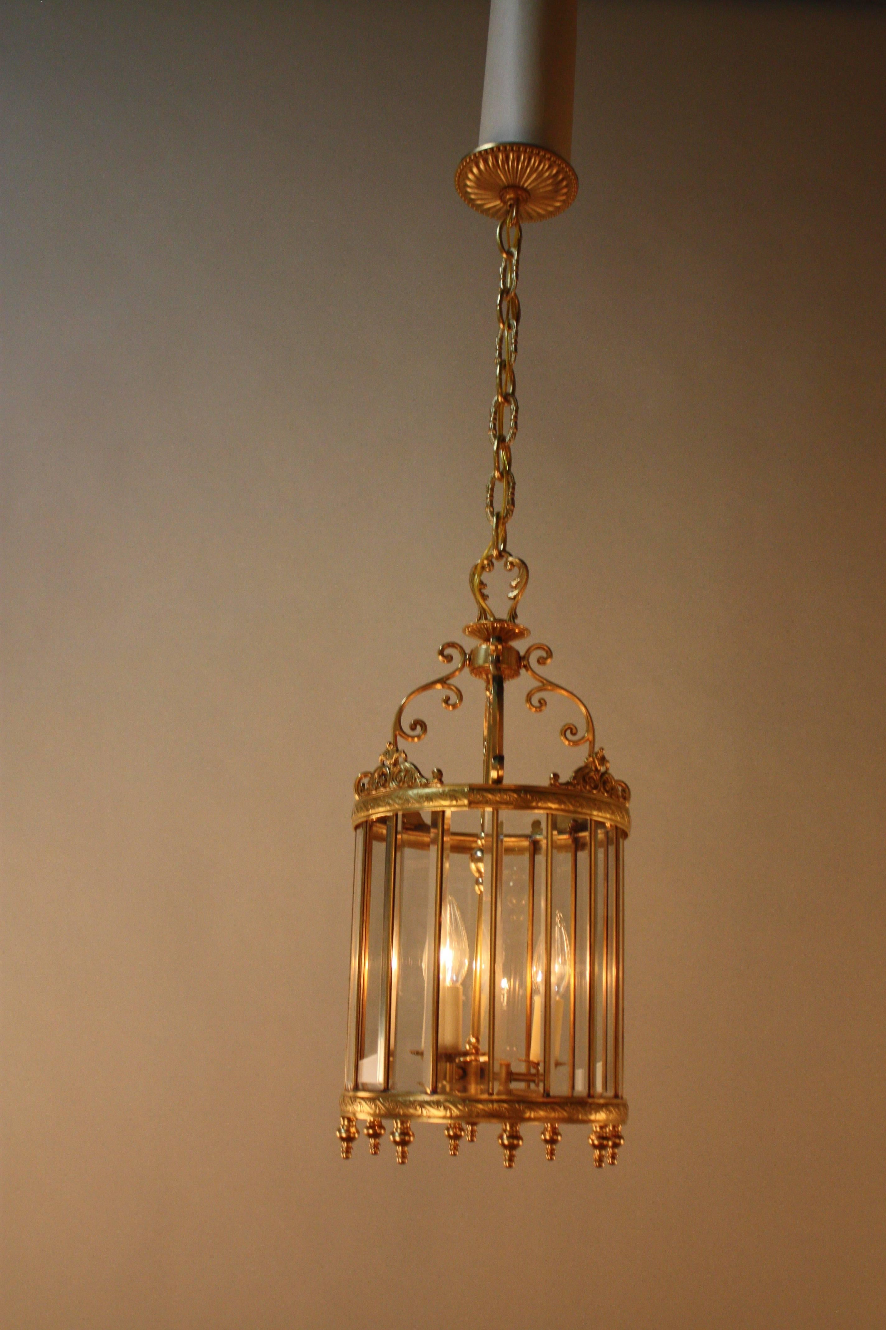 Elegant three-light bronze lantern with multi beveled glass panels.
Fully installed with one link of chain and canopy is 24