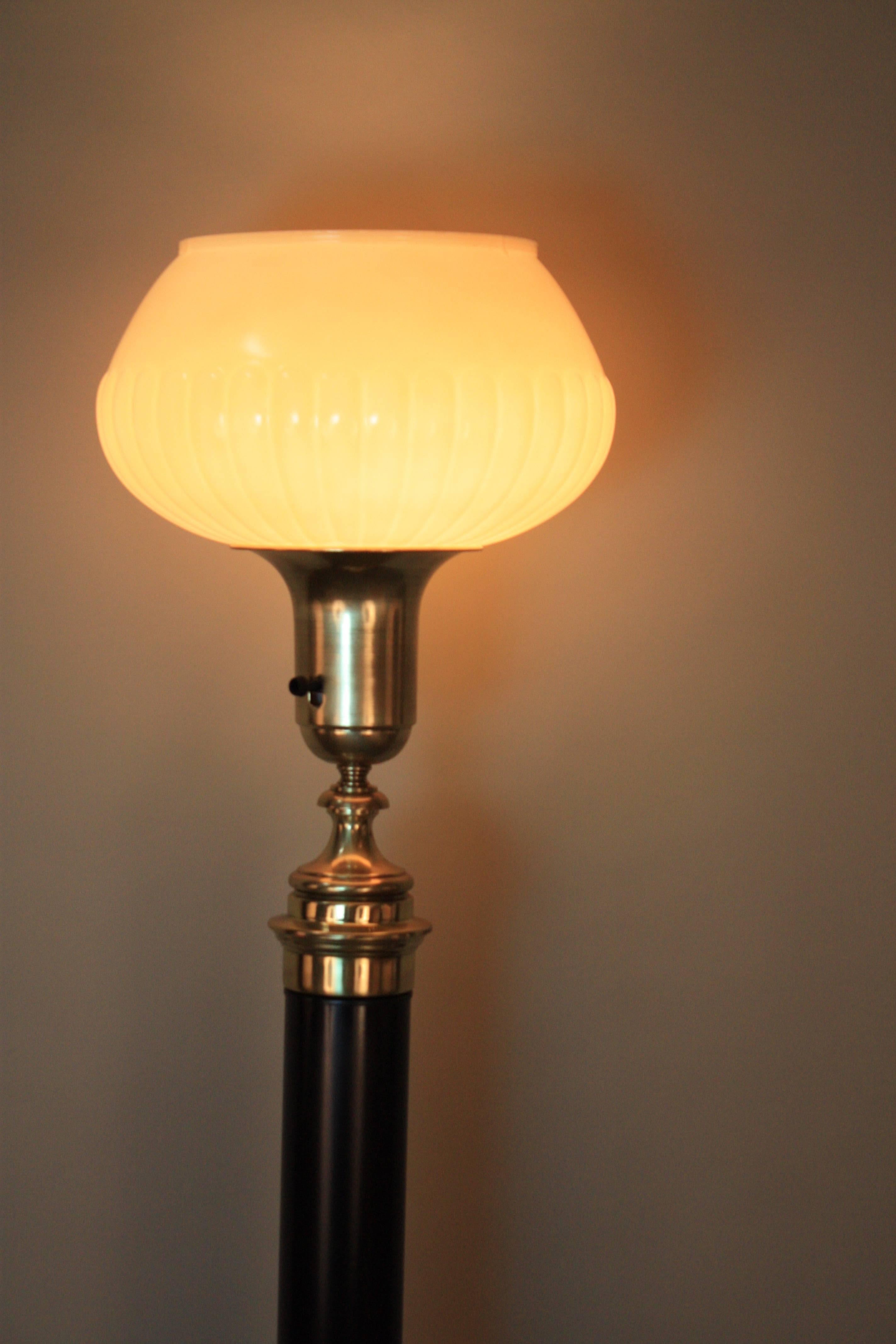 A Classic design American 1930s torchiere floor lamp in brass and black lacquer.
Three way socket 100-300watts.