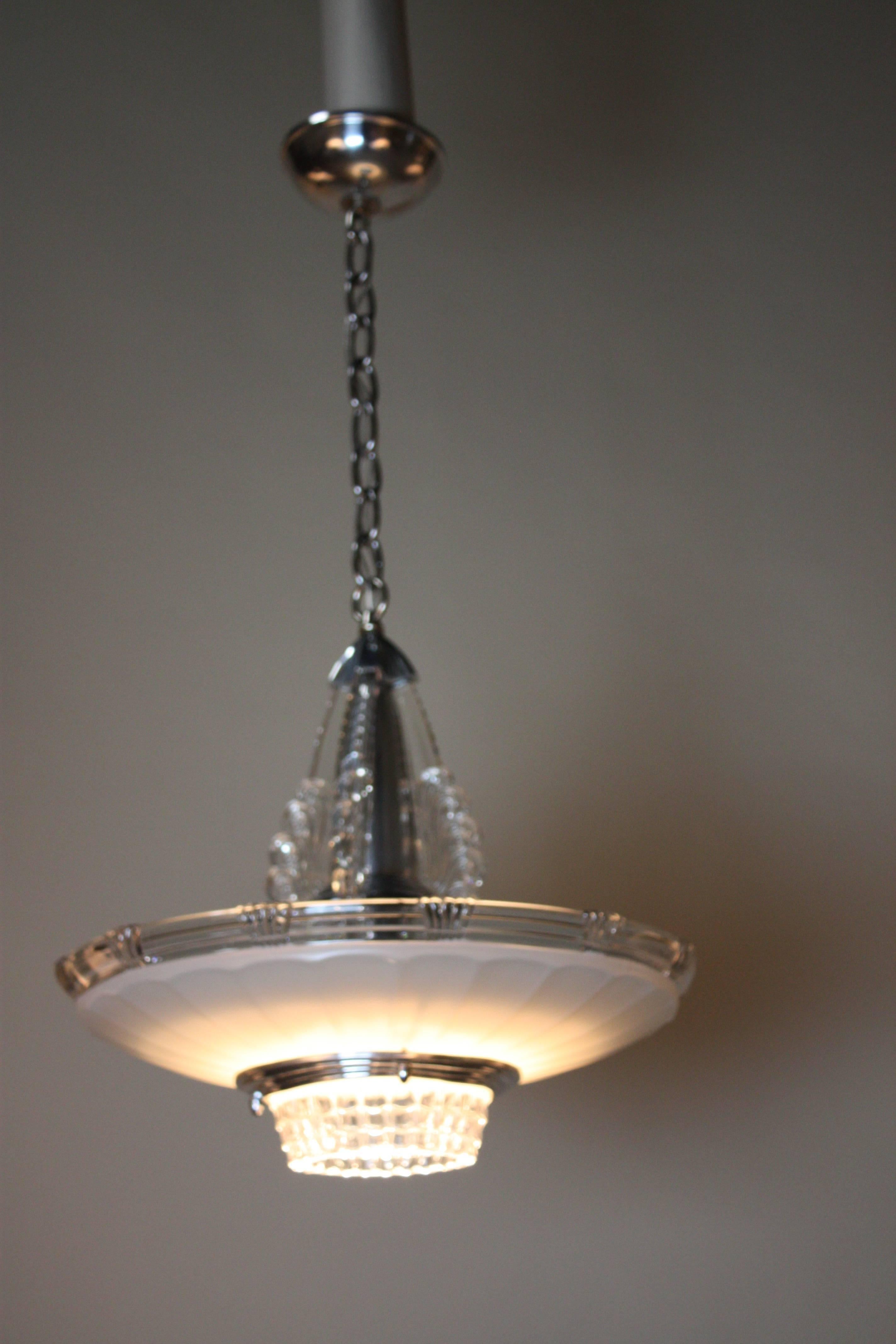 An elegant 1930s American Art Deco chandelier. Glass is combination of cream color and clear with polished aluminium hardware.