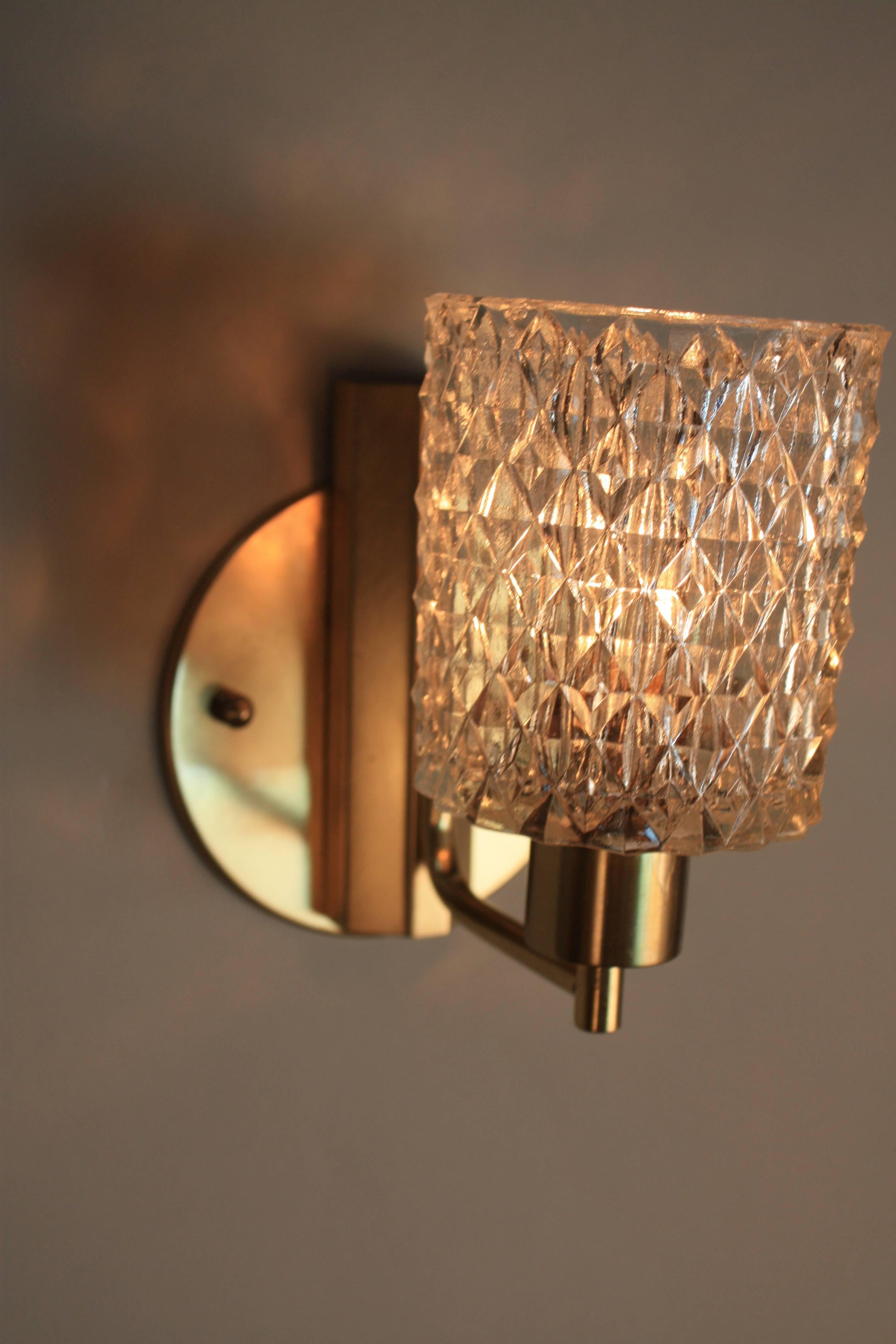Simple design but elegant, single light 1970s glass and bronze Italian wall sconces.