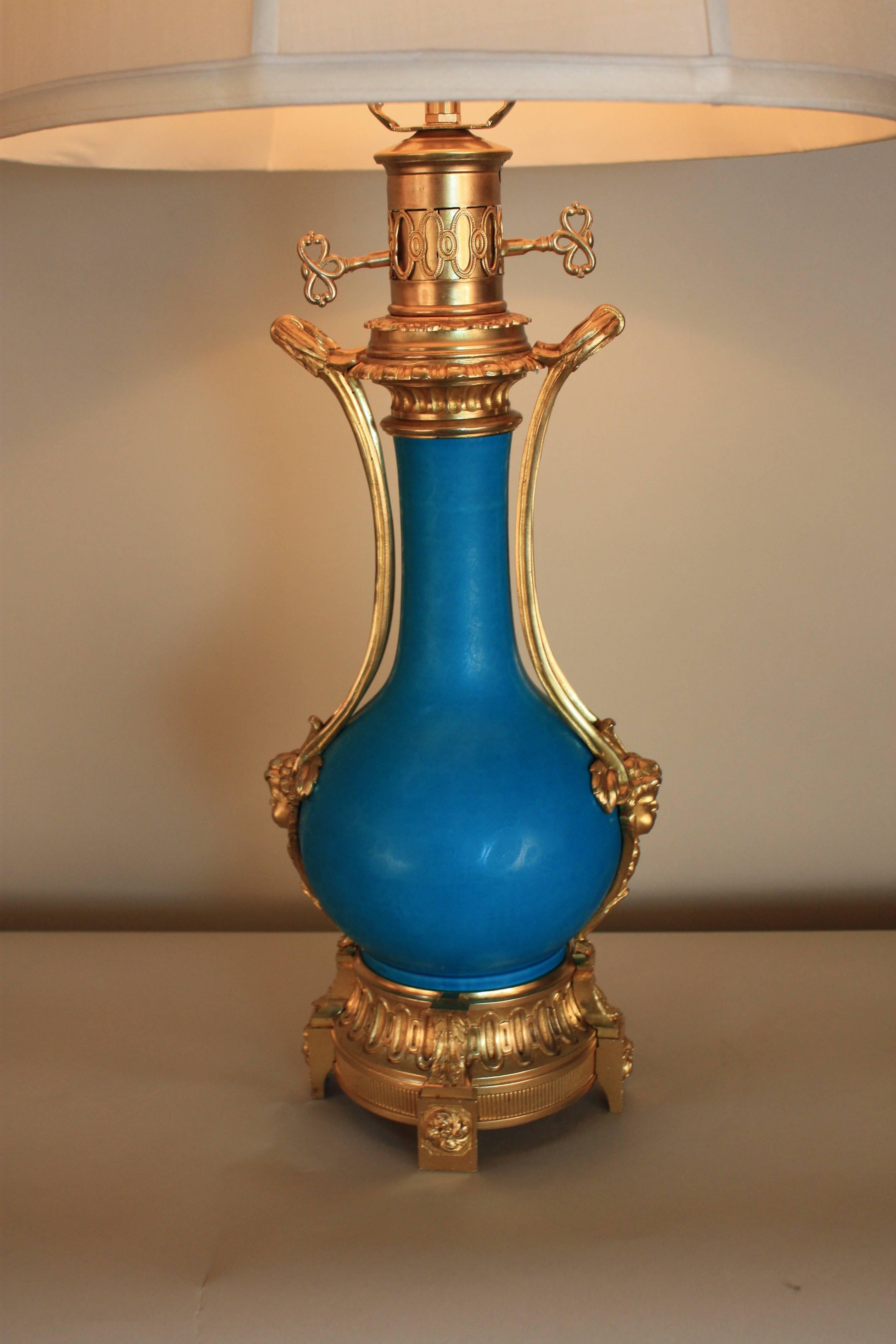 Elegant 19th century table lamp. Electrified porcelain and dore bronze oil lamp and fitted with silk lampshade.