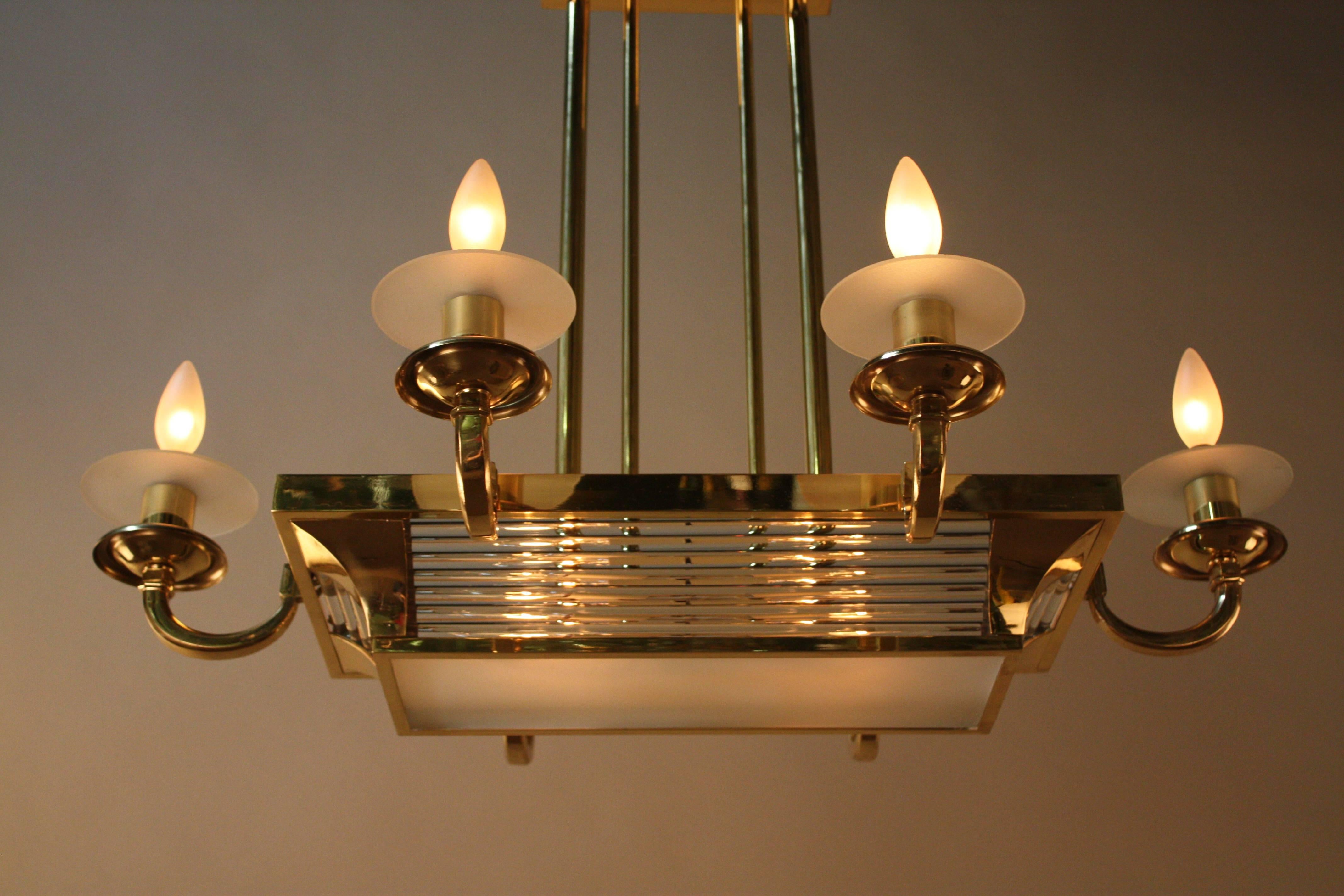 Elegant Art Deco chandelier features crystal rods, frost glass housed in polish bronze.