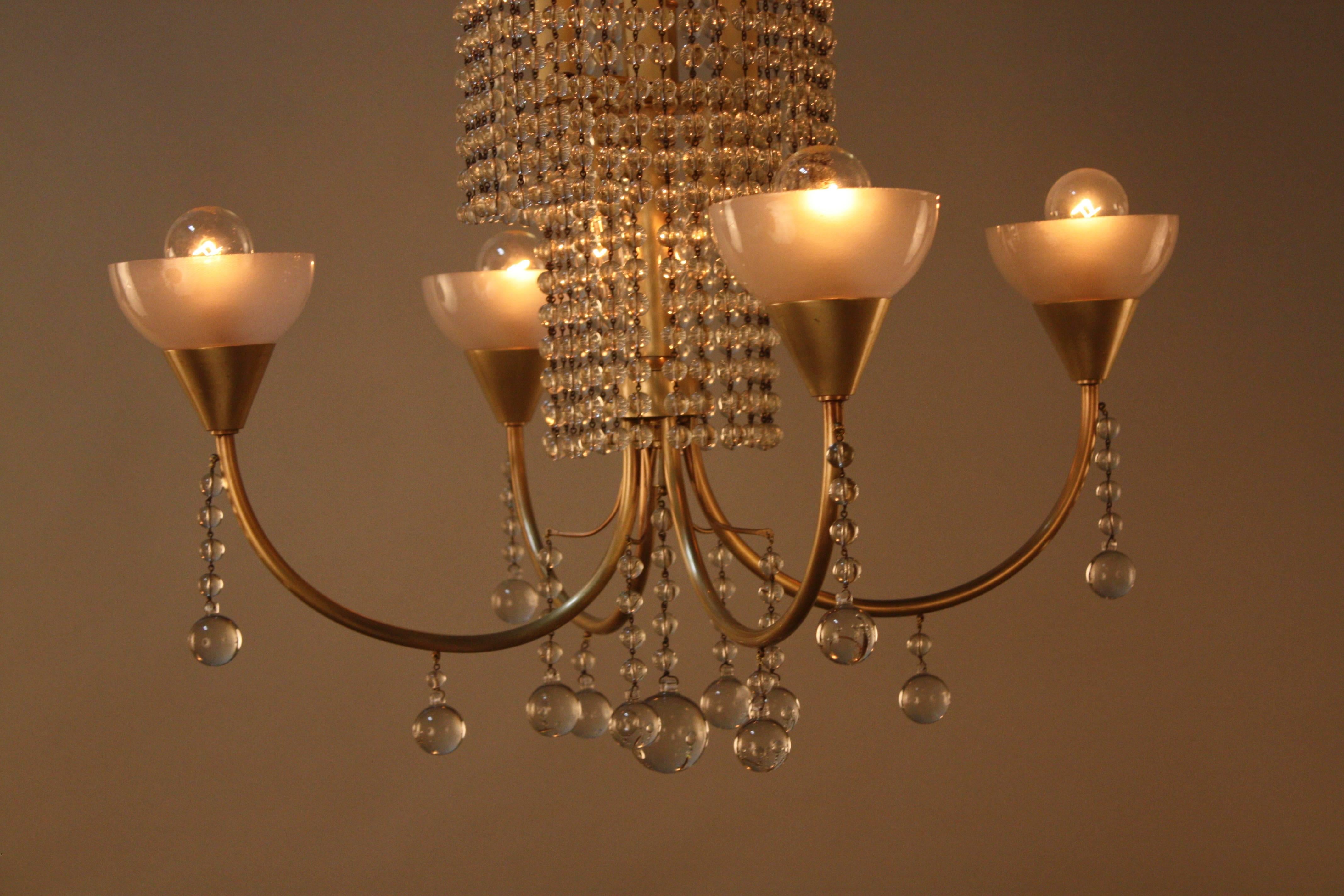 Elegant four-arm and total of ten light crystal and bronze chandelier.
Minimum height fully installed 32