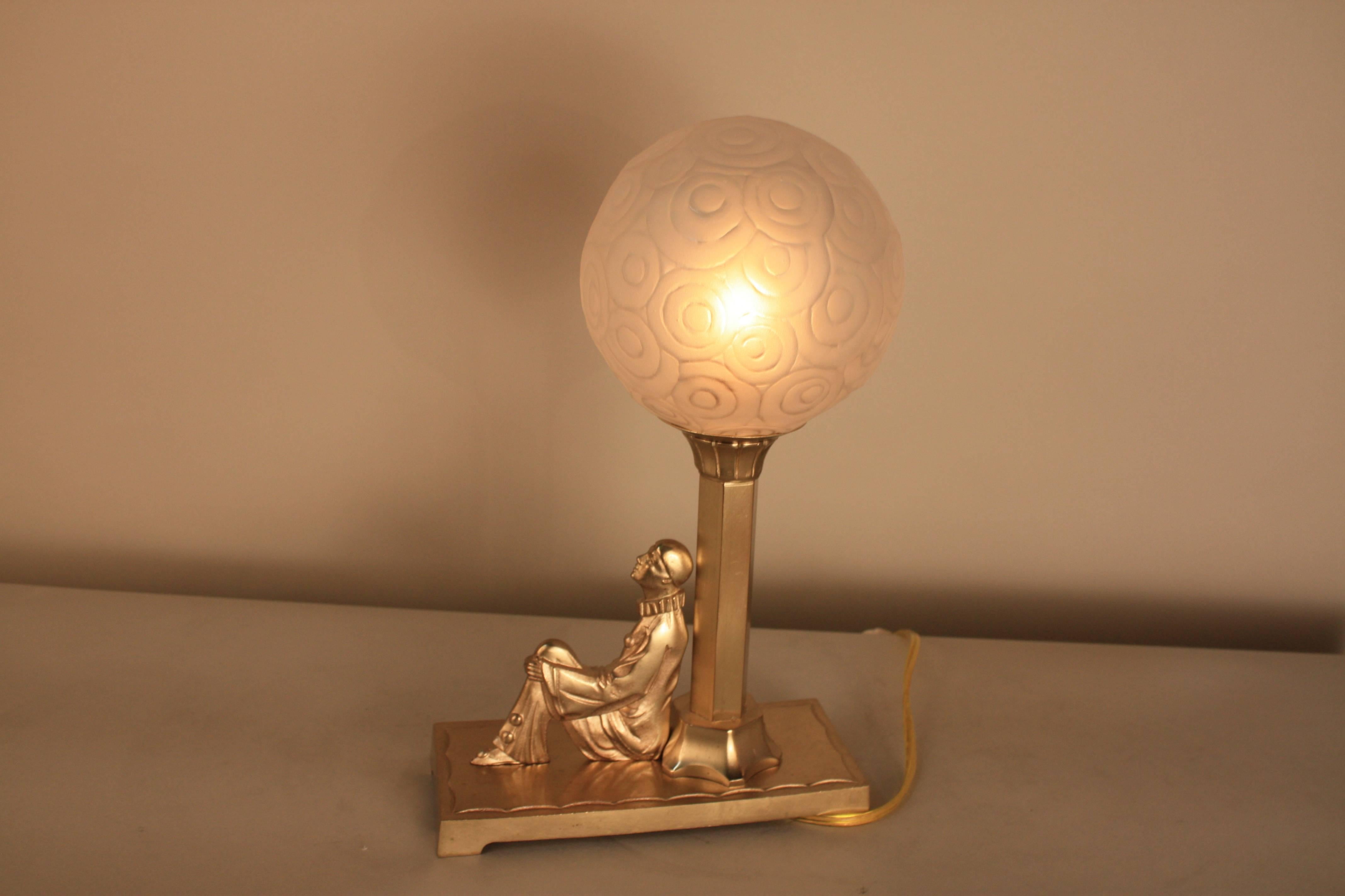 Early 20th Century Art Deco Bronze Harlequin and Glass Shade Table Lamp