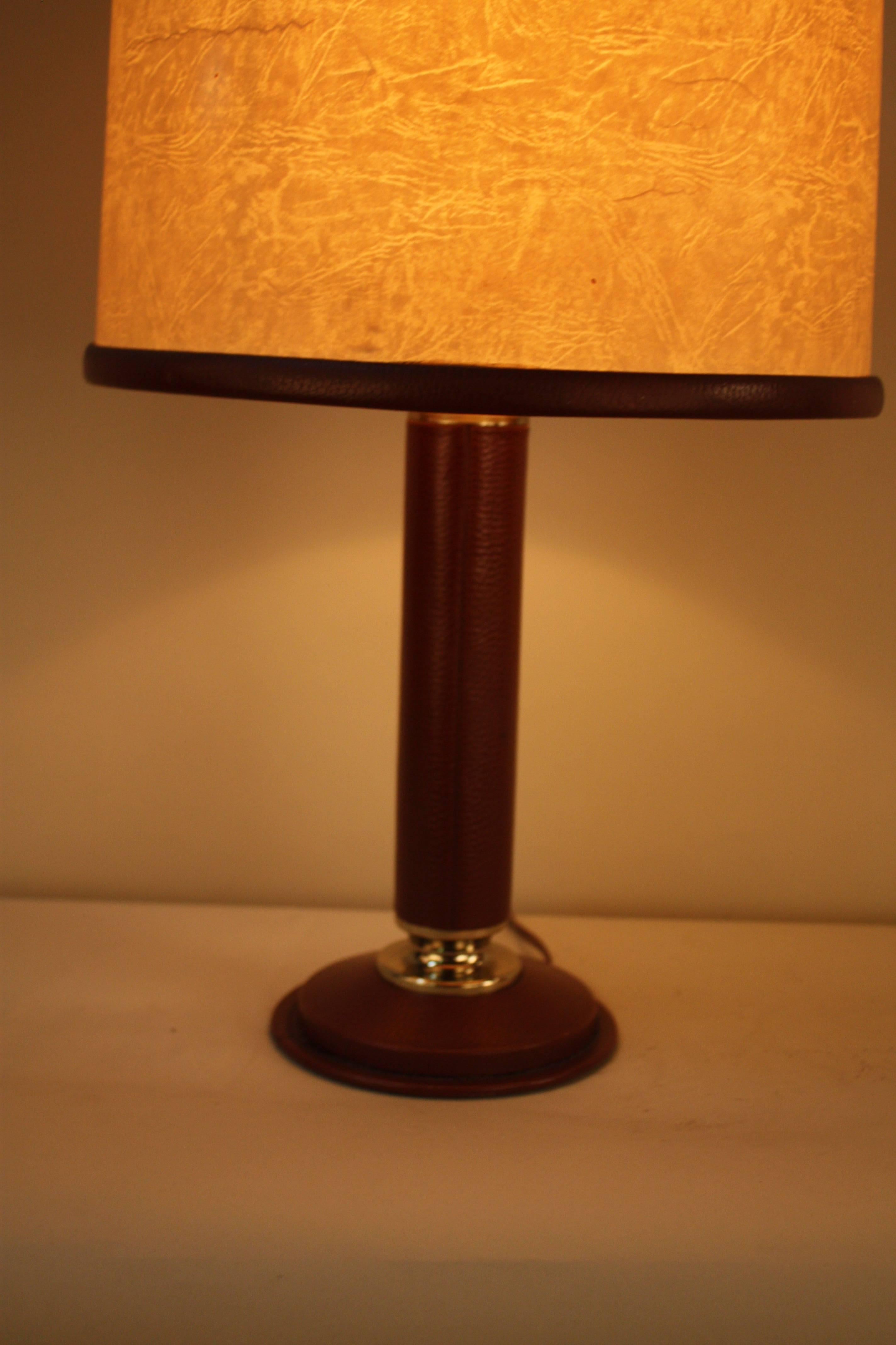 A classic leather table lamp with original leather trimmed lampshade by Le Tanneur.