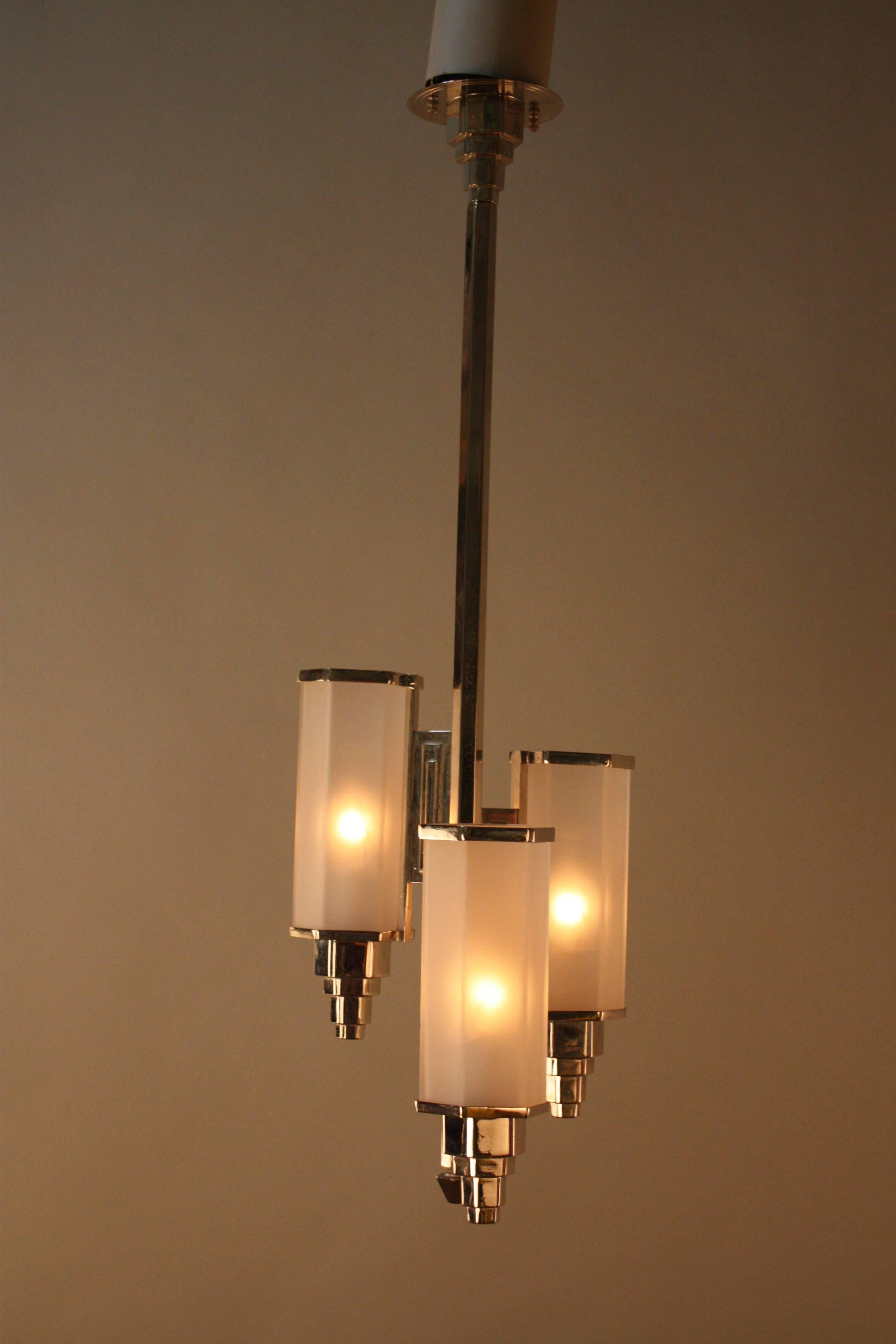 A rare Art Deco chandelier, three hexagon clear Frost shades with polished nickel frame.