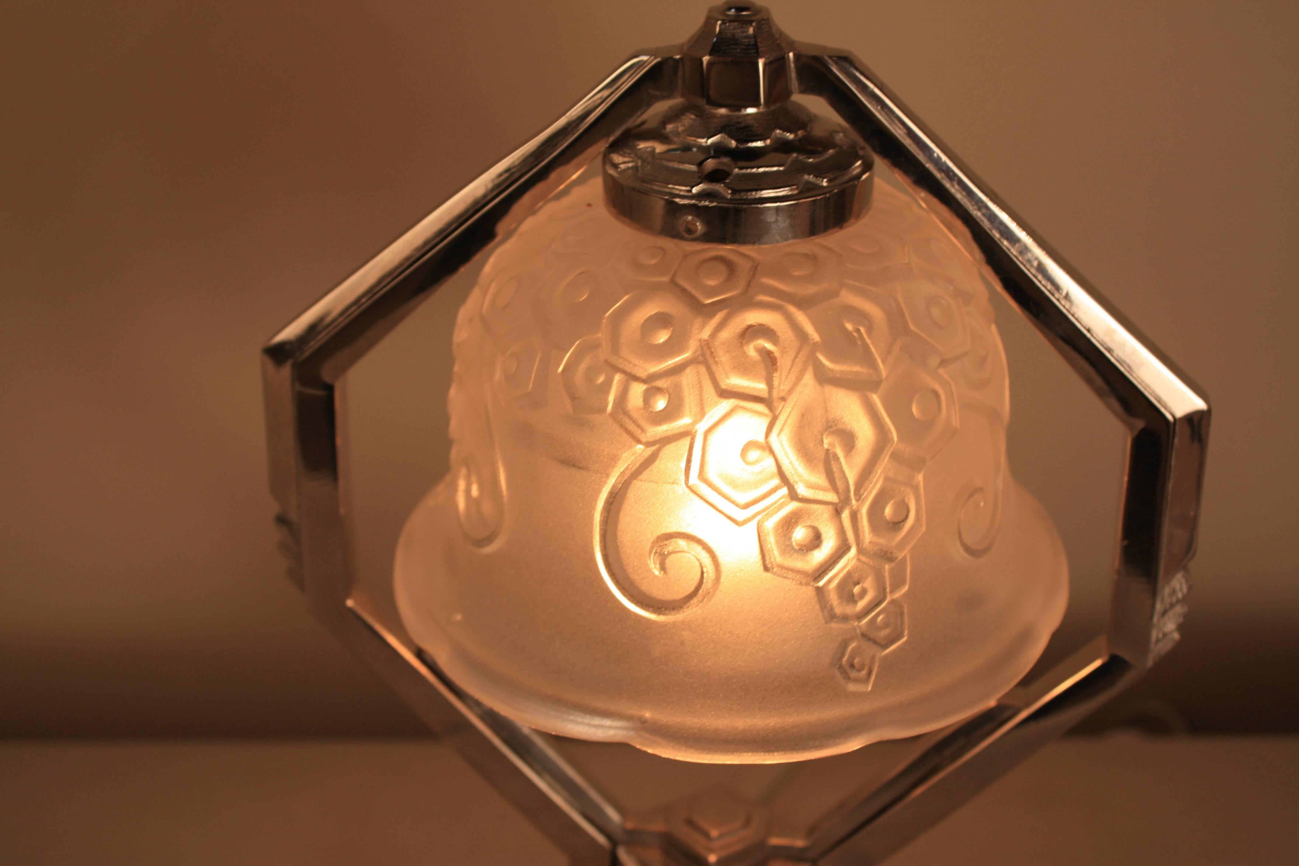 A rare and beautiful nickel on bronze French Art Deco table lamp with clear frost glass shade.